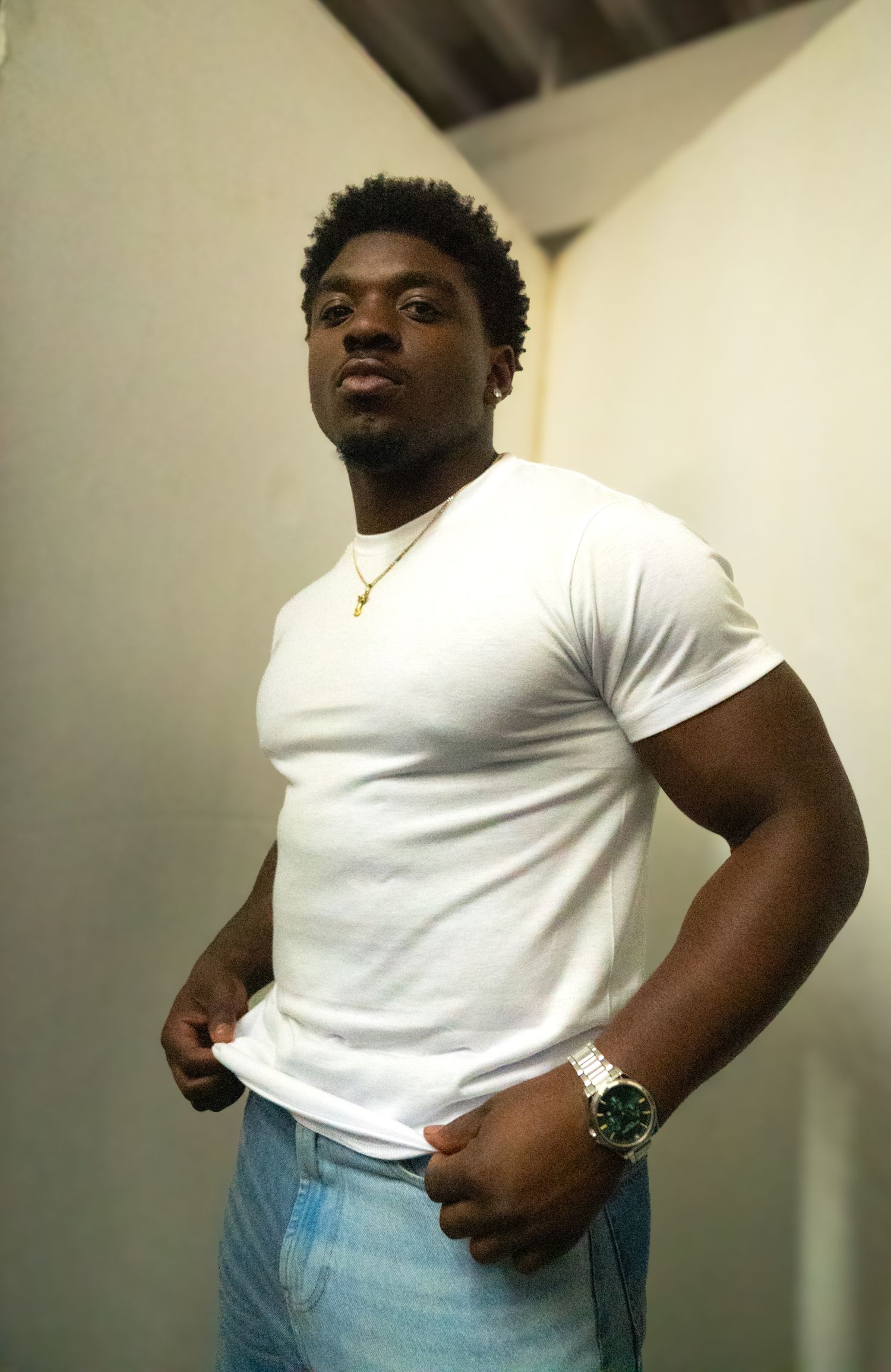 Athletic person in white t-shirt and jeans demonstrates various poses against neutral background.