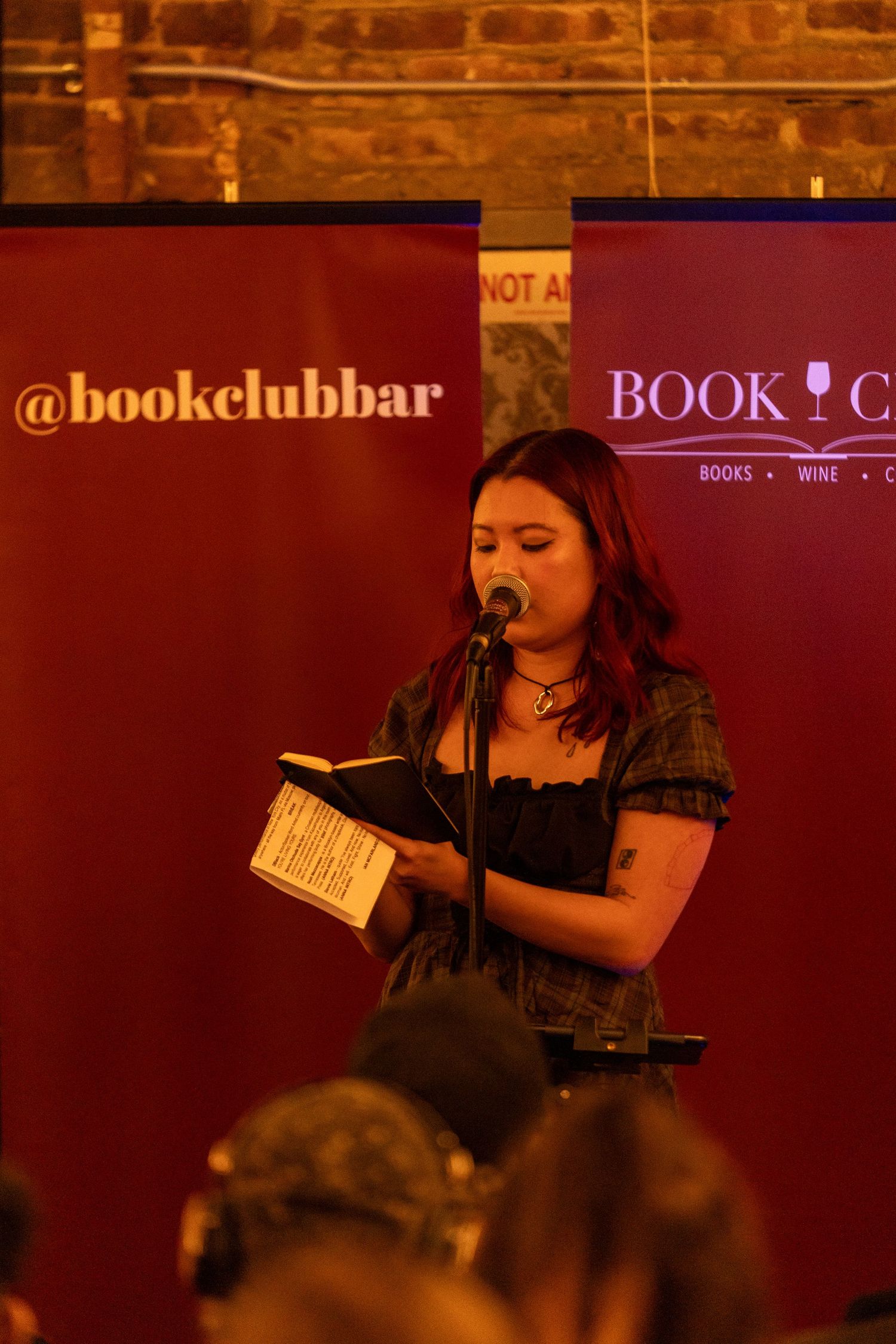 Performance at Book Club Bar venue with red ambient lighting.
