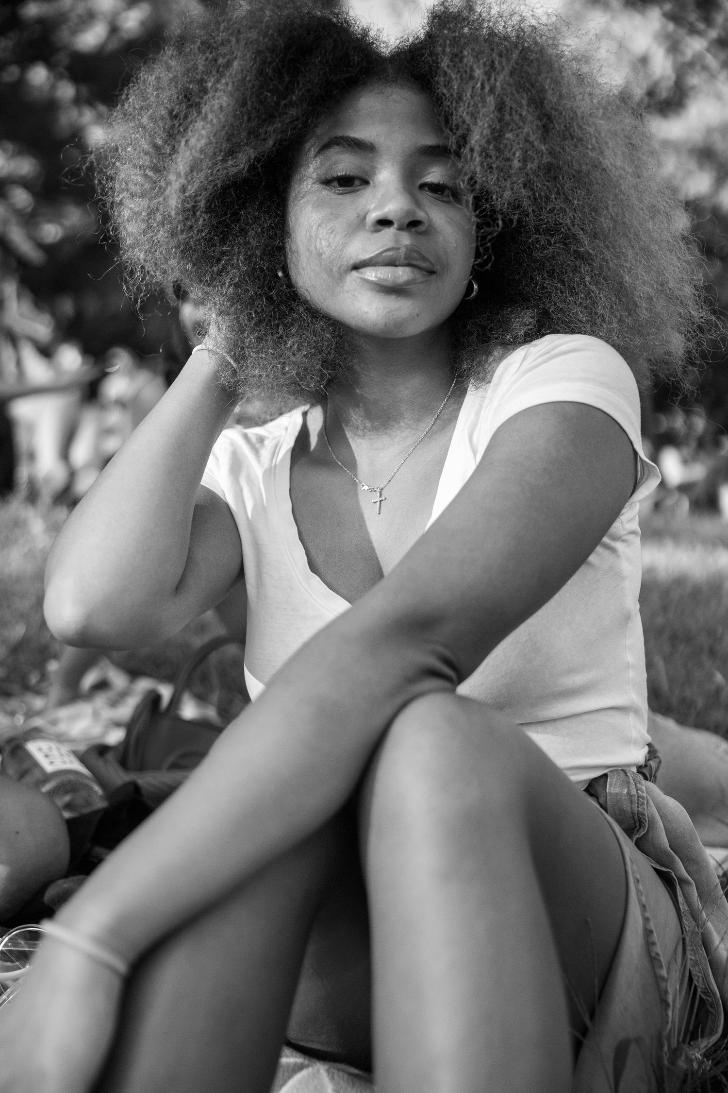 Portrait in black and white showing natural curly hair and casual style.