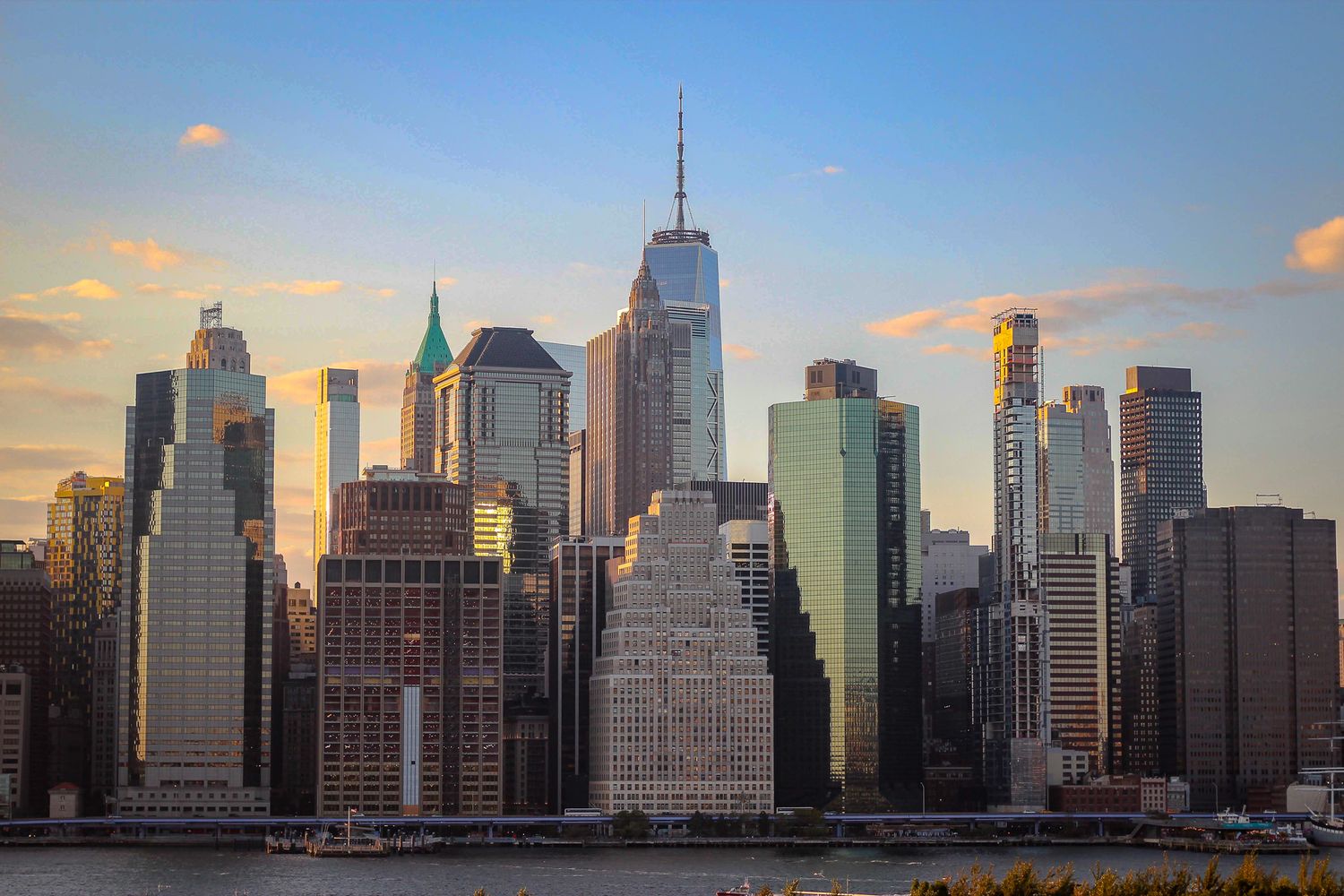 Manhattan skyline at sunset showcasing iconic skyscrapers including Empire State Building.