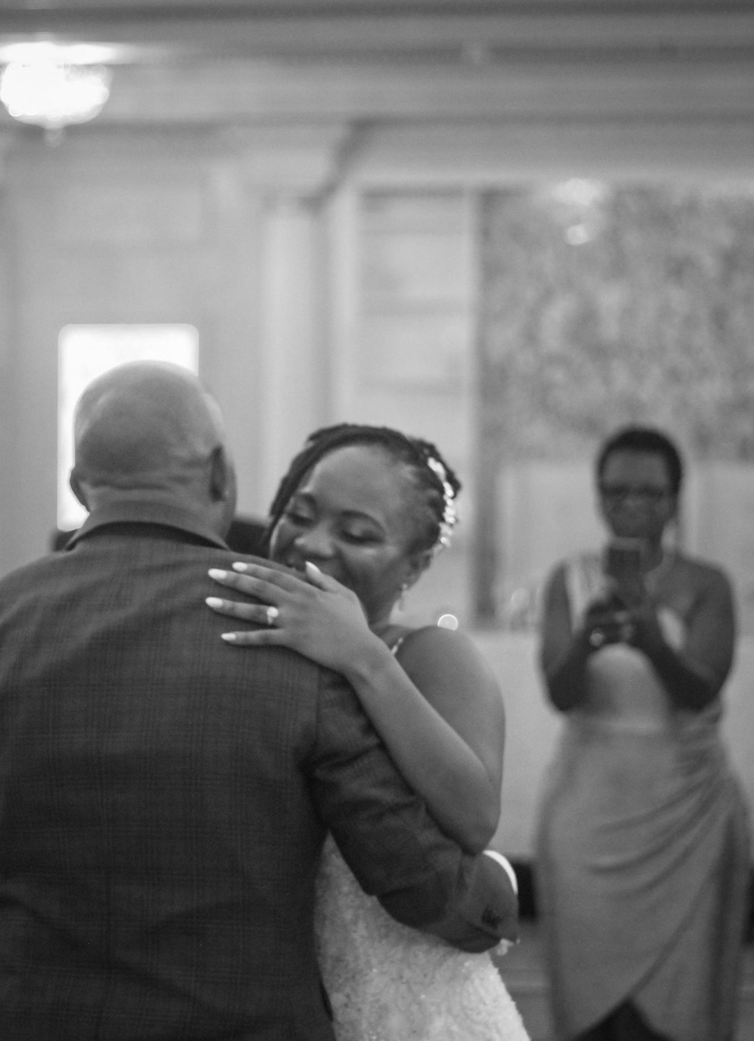 Emotional black and white sequence of a dance between two people at a wedding reception.