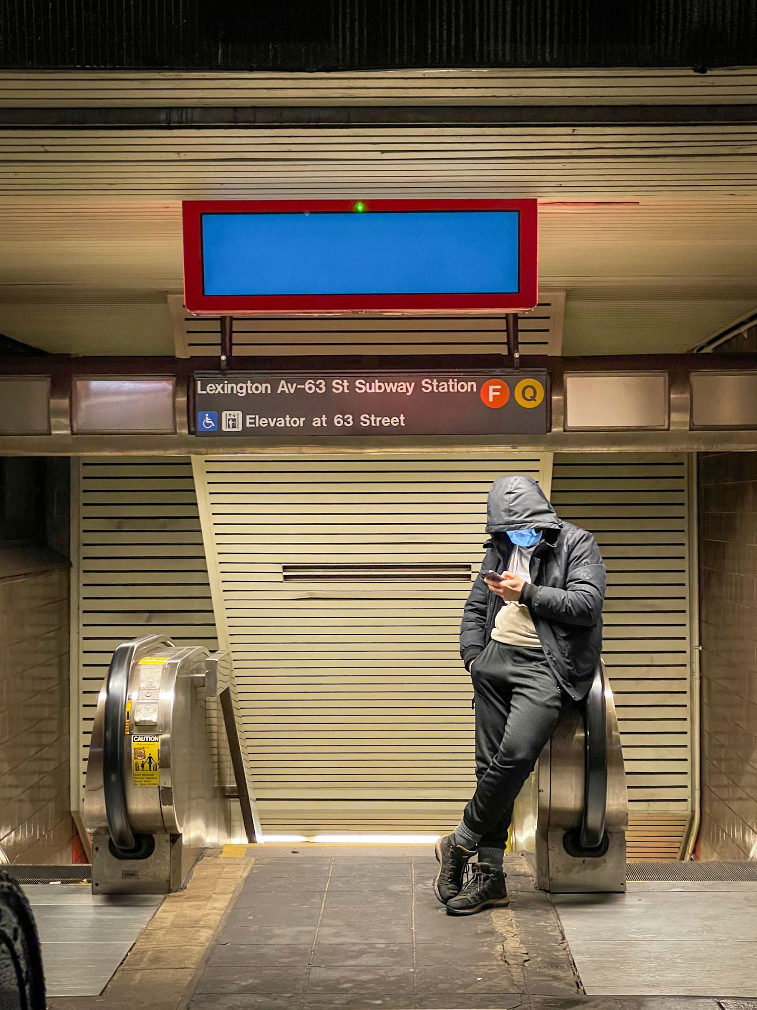 Empty subway station platform at Lexington Avenue with closed shutters.