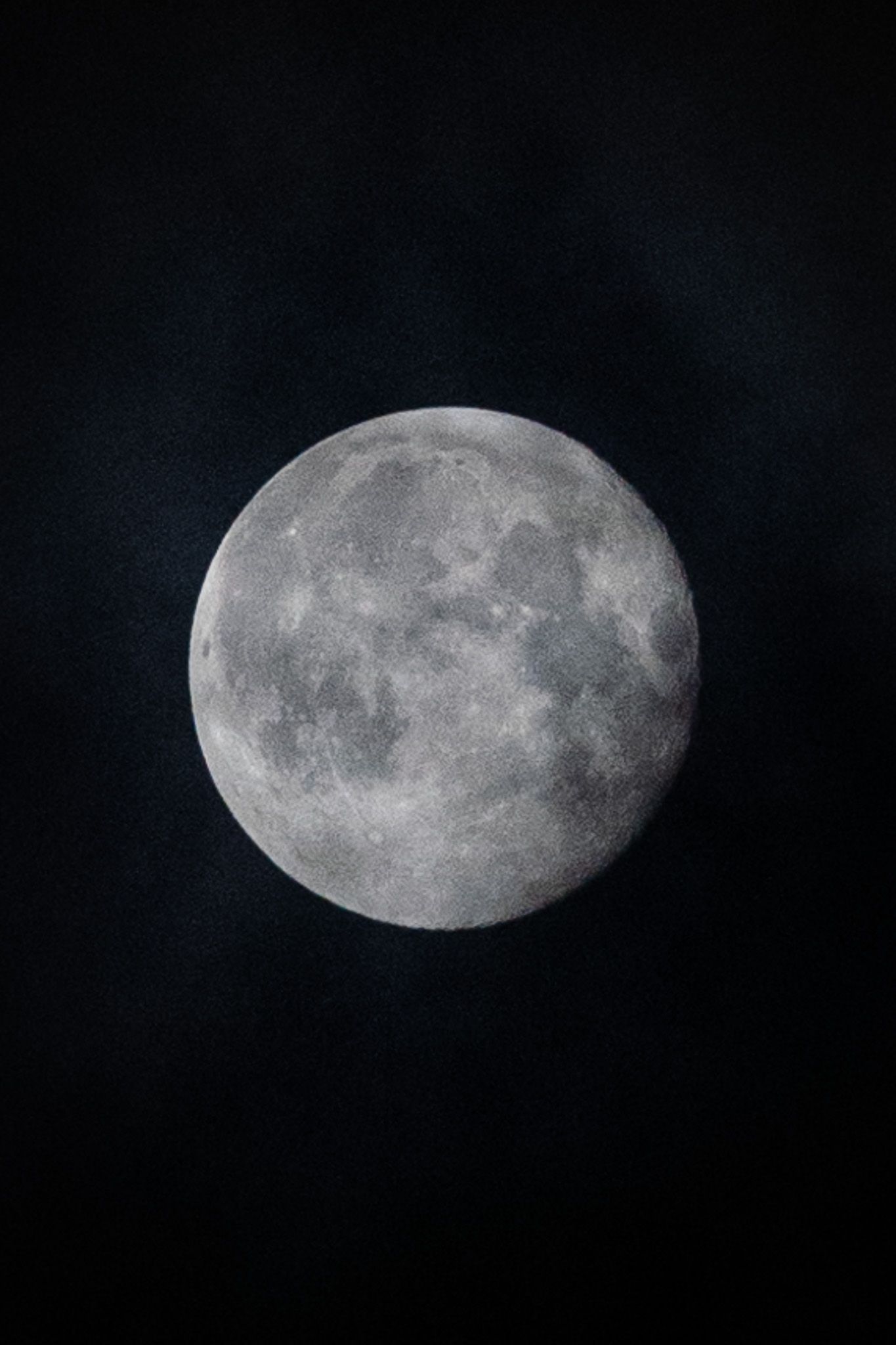 Detailed black and white sequence of the waning gibbous moon phases against dark sky.