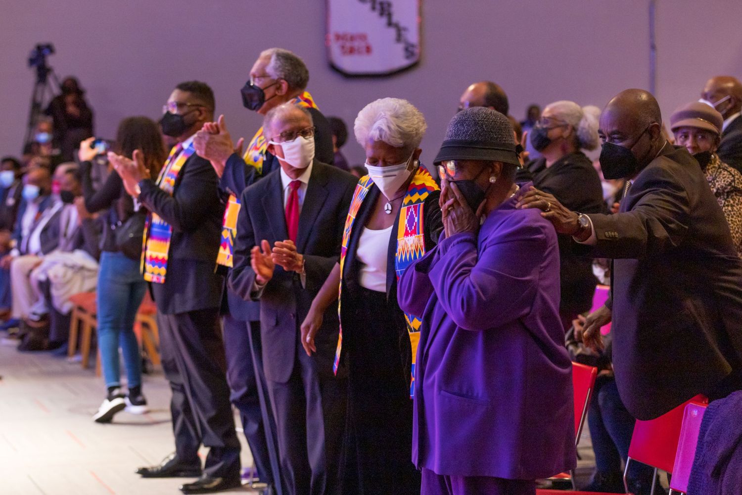 A group of people stand together during what appears to be a formal ceremony or event.