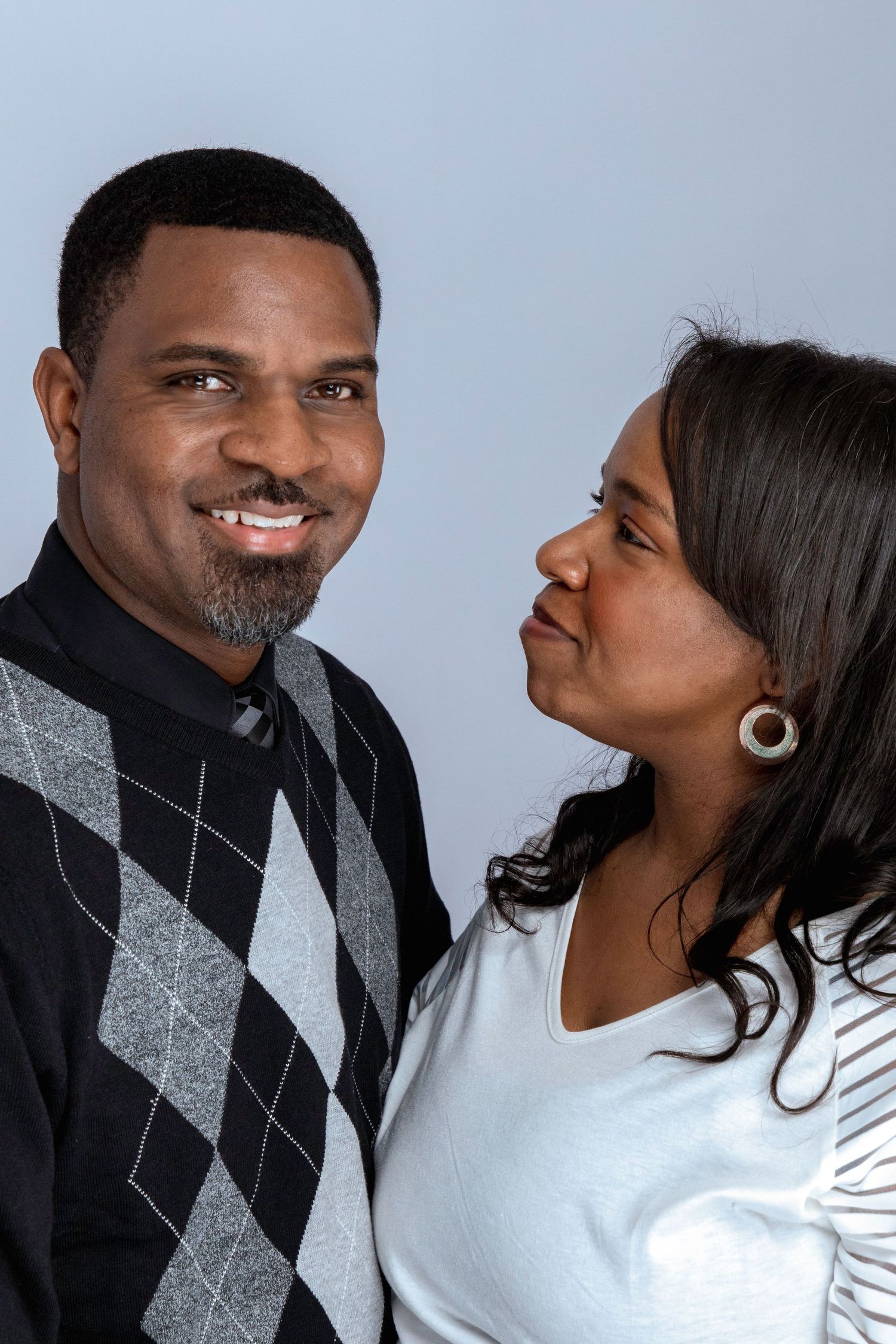 Couple sharing intimate moment in studio portrait session.