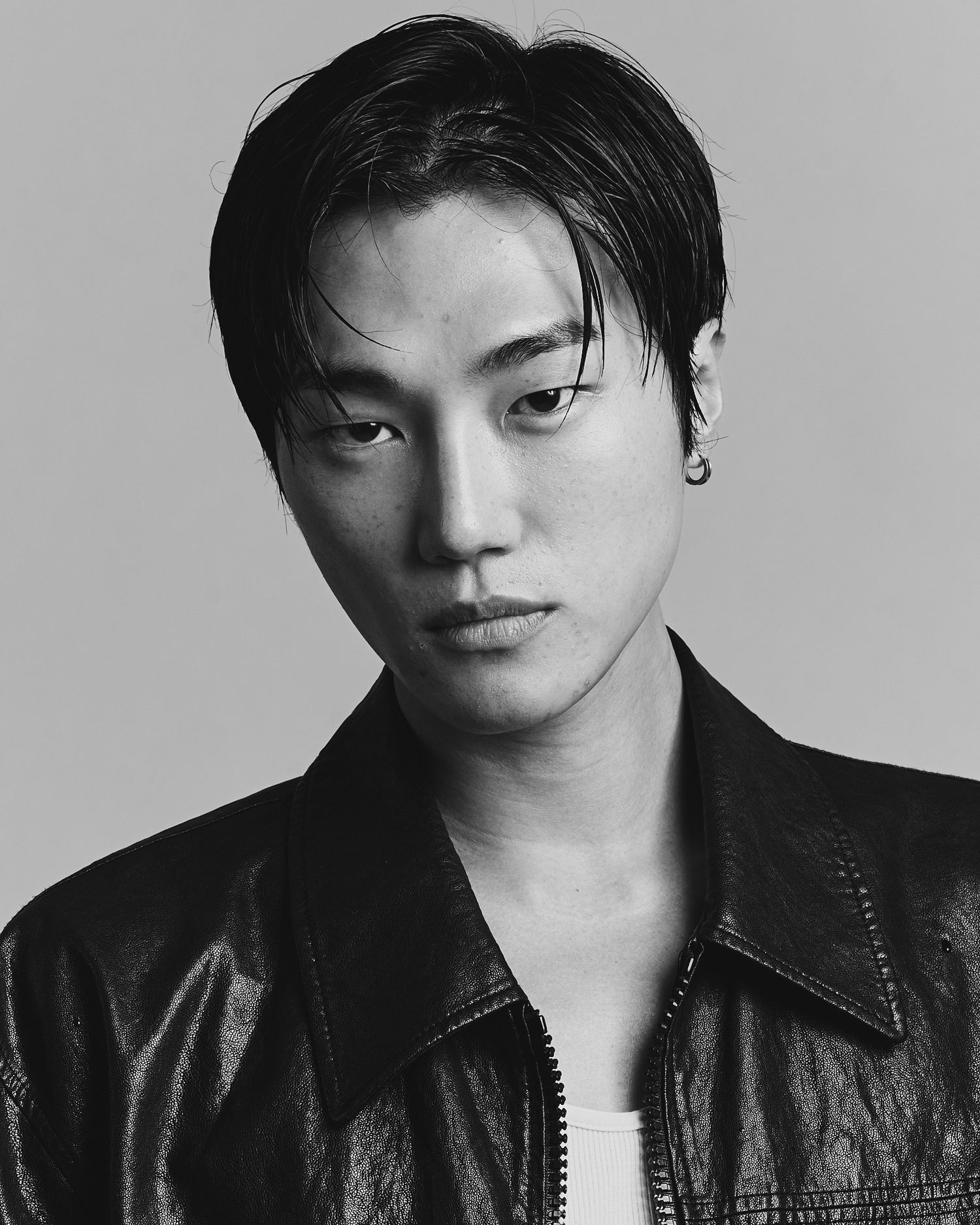 Black and white portrait series showing dramatic side profile poses in a leather jacket against a plain background.