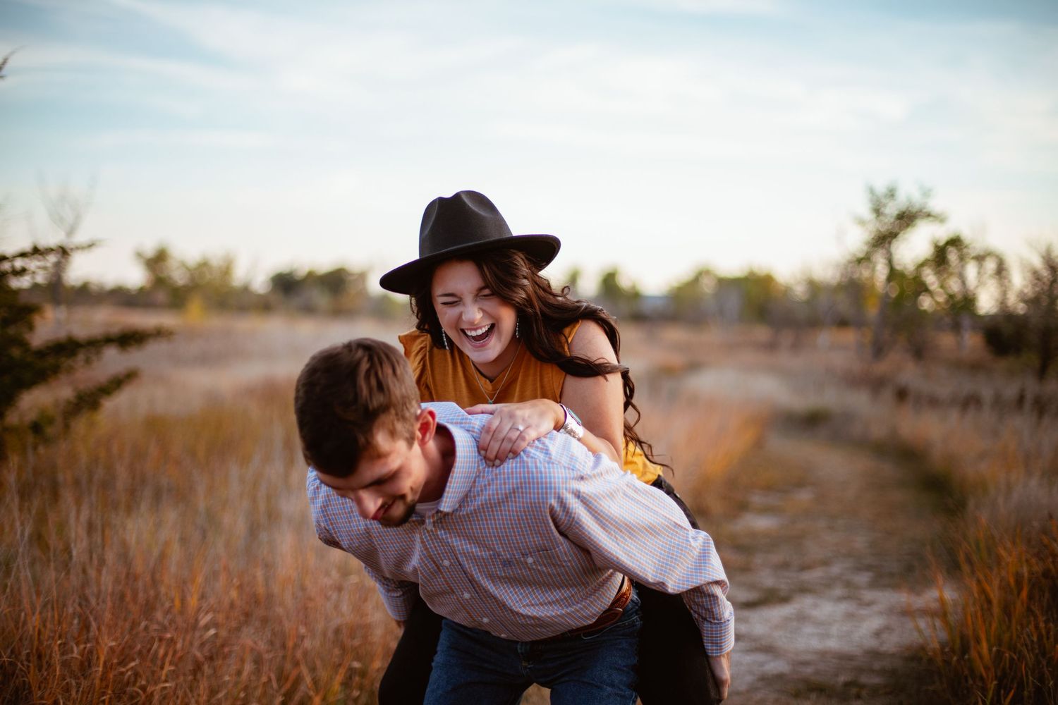 Playful moment captured in rustic field setting.