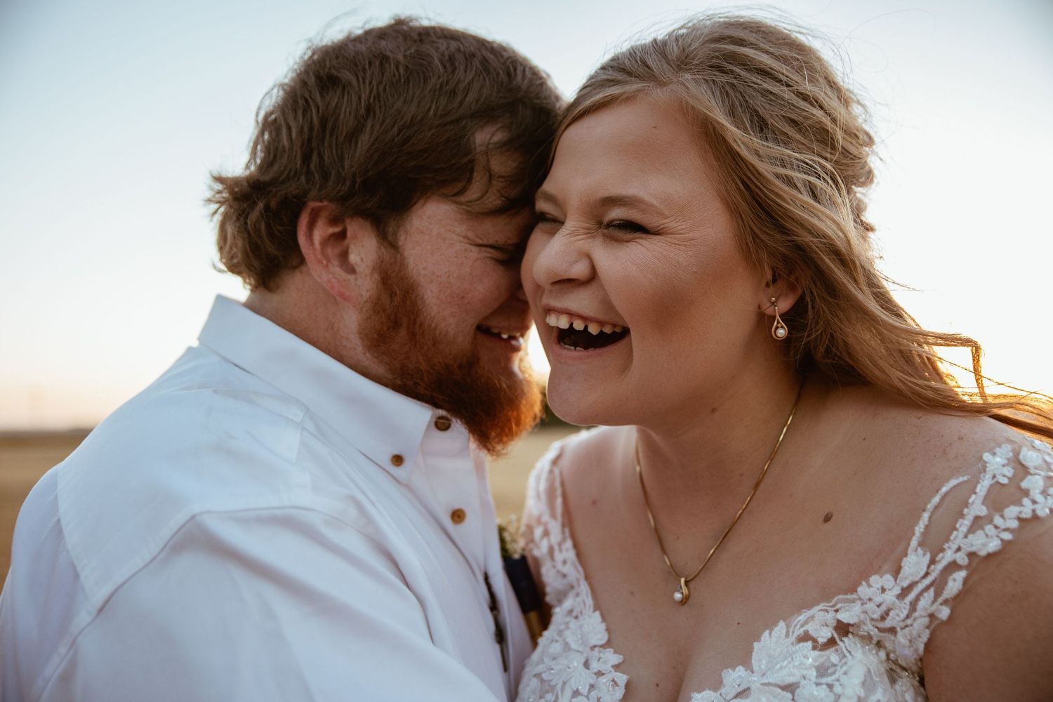 Joyful couple sharing intimate moment during wedding celebration.