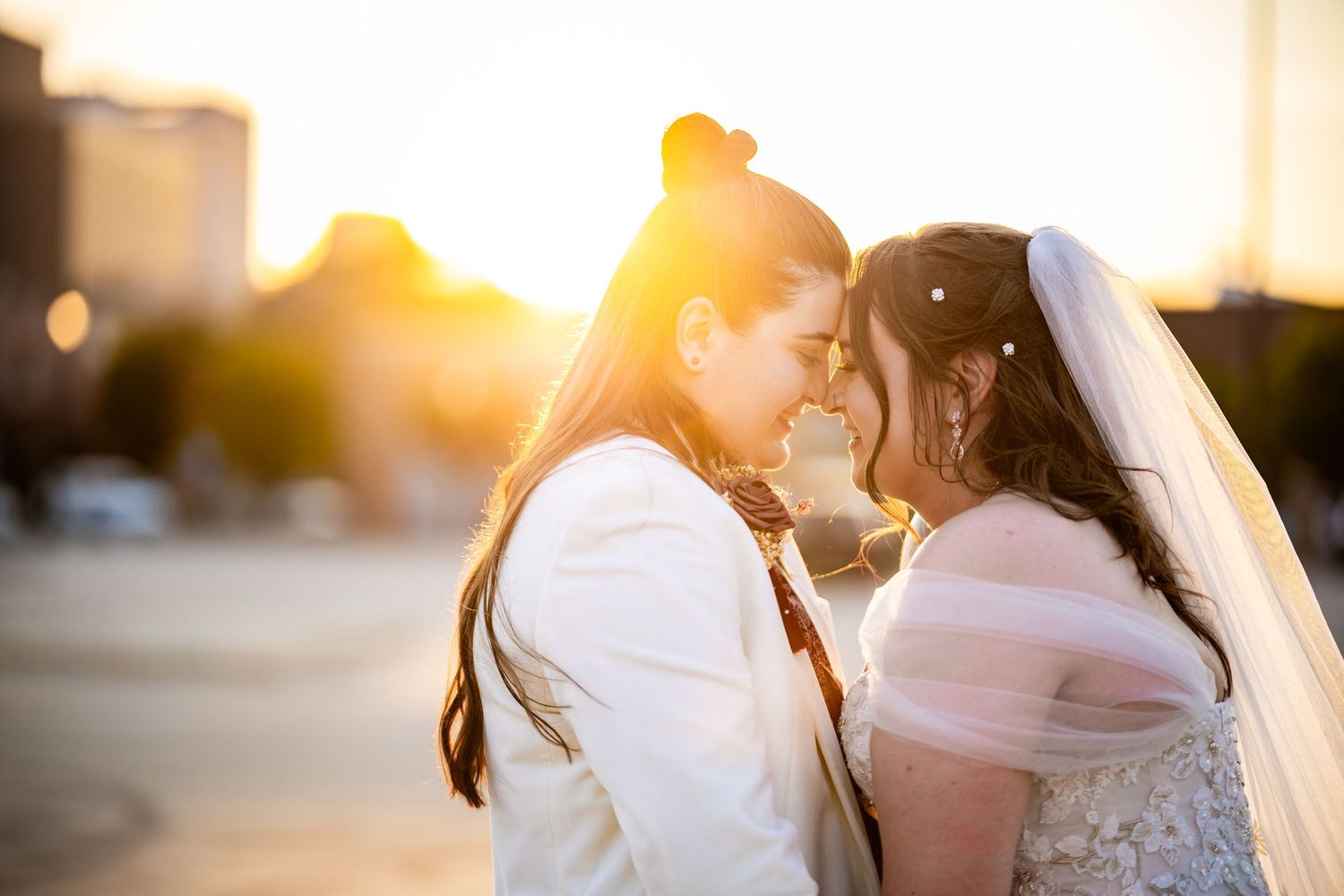 A sunset wedding portrait captures an intimate moment between newlyweds.