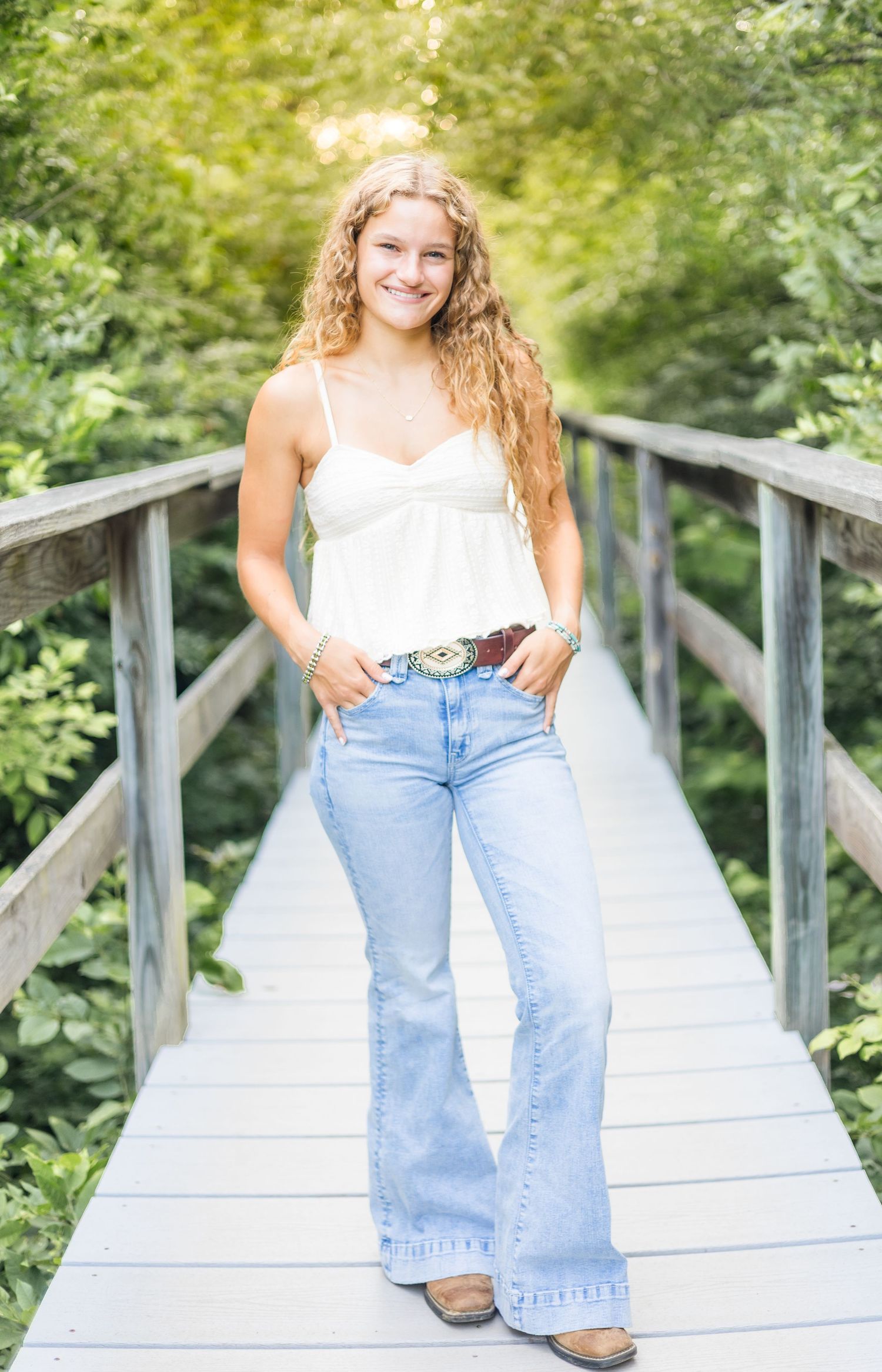 A series of casual portraits showing someone in a white top and jeans sitting on a wooden bridge in a natural setting.