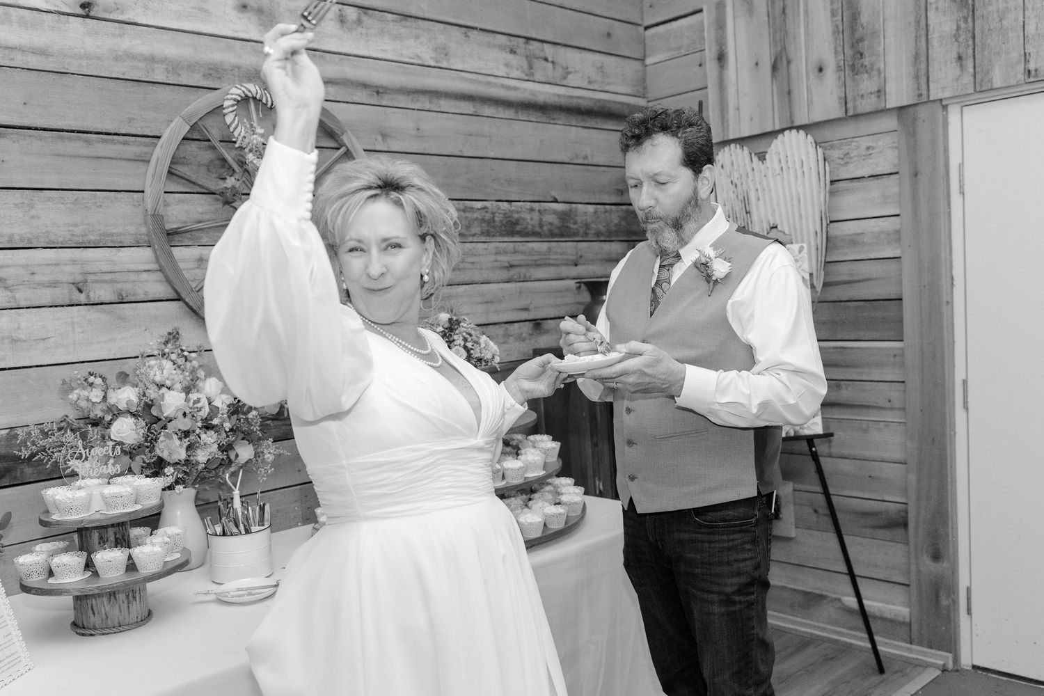 Black and white photos of wedding couple dancing in rustic barn setting.