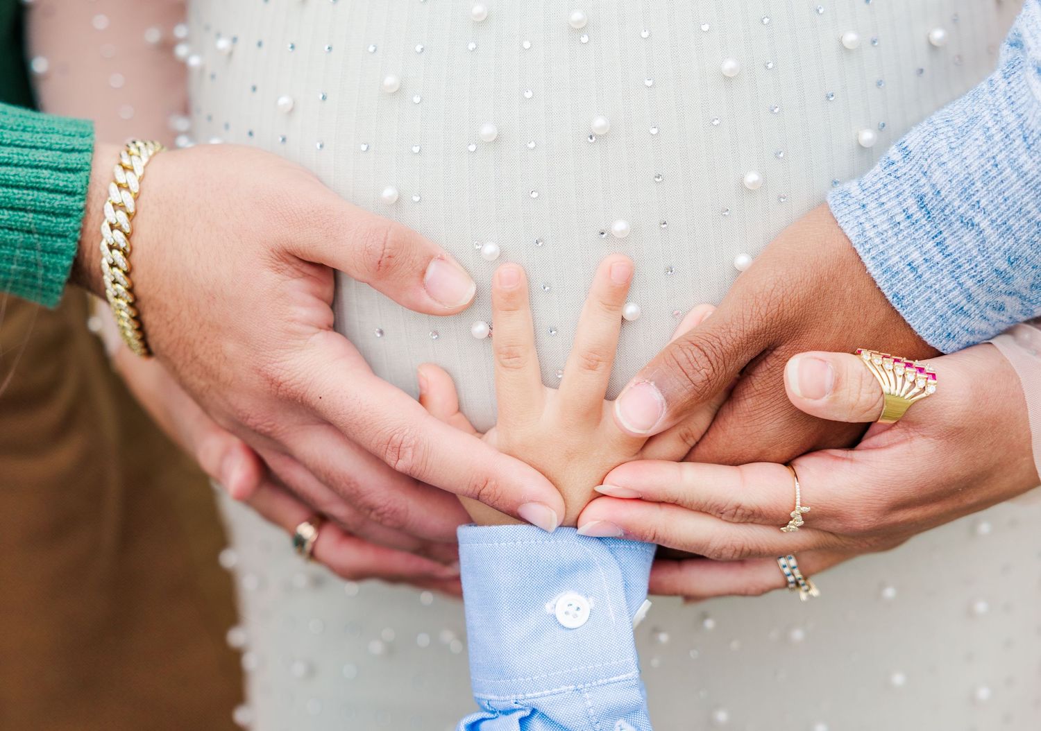 Close-up shots of hands holding ultrasound photos against a white textured background.