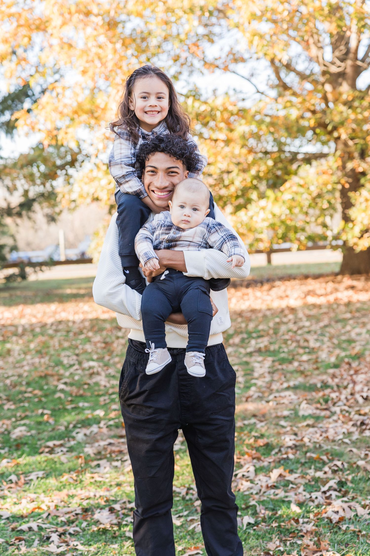 Candid moments of playful interaction between two people outdoors on an autumn day with golden leaves in the background.