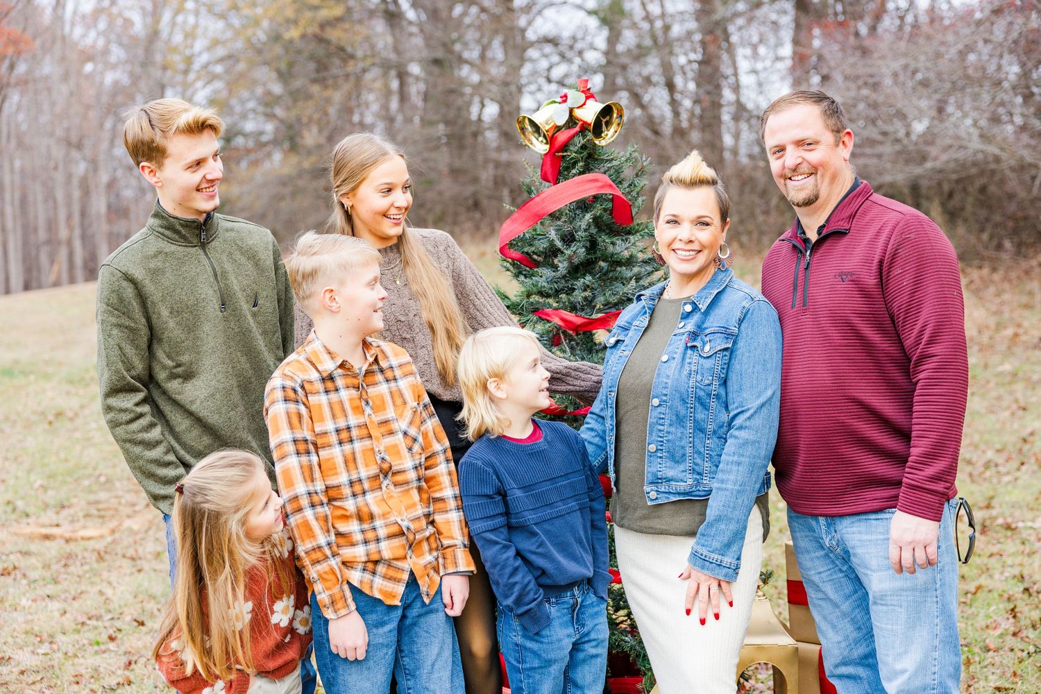 Multiple outdoor family portrait shots arranged in a collage with holiday decorations visible.