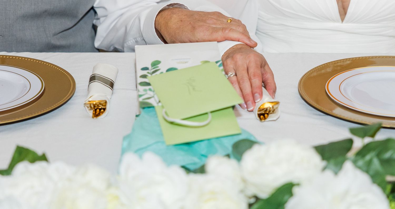 Close-up with hands holding decorative serving utensils.