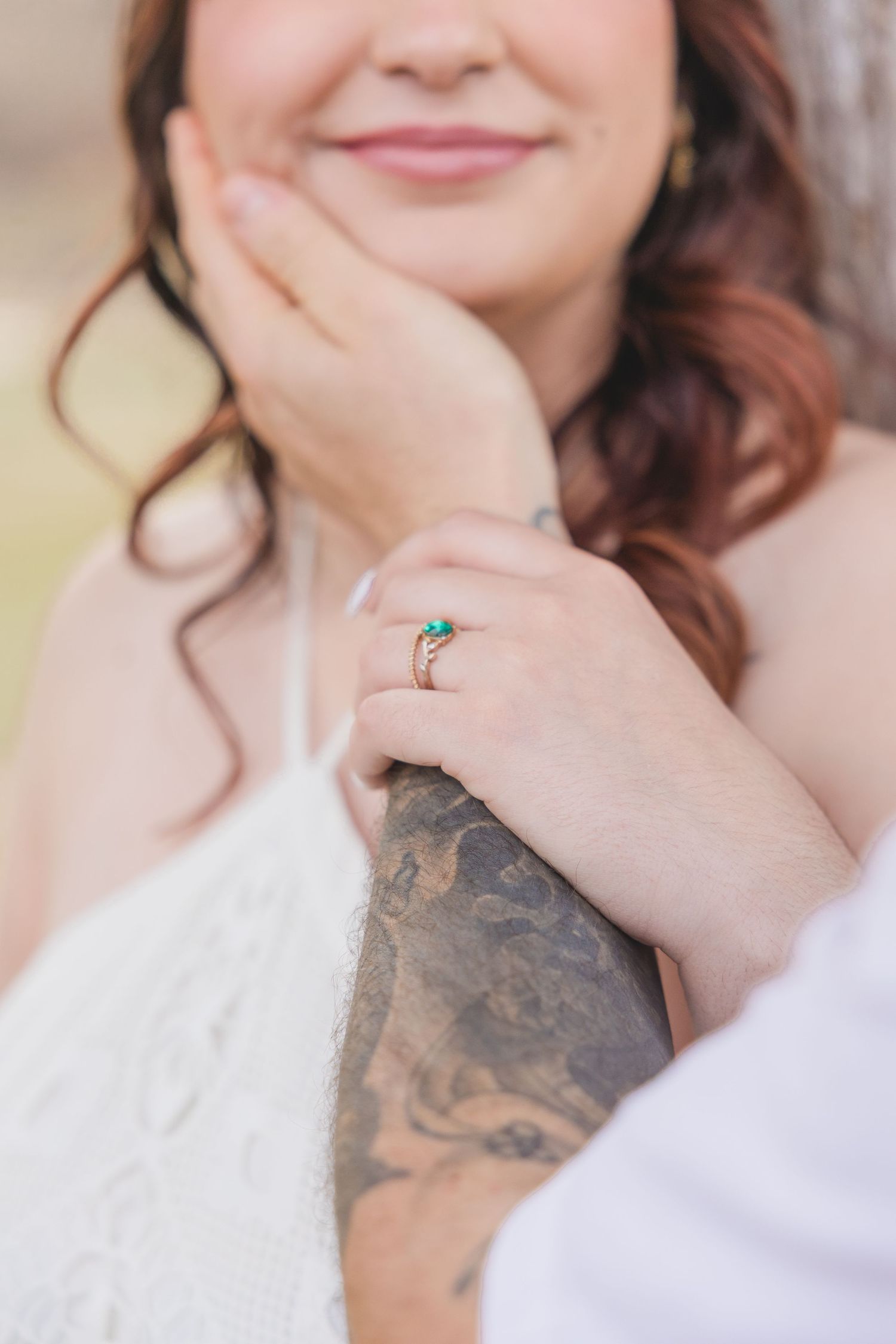 A series of close-up shots showing hands with tattoos and jewelry against a light background.