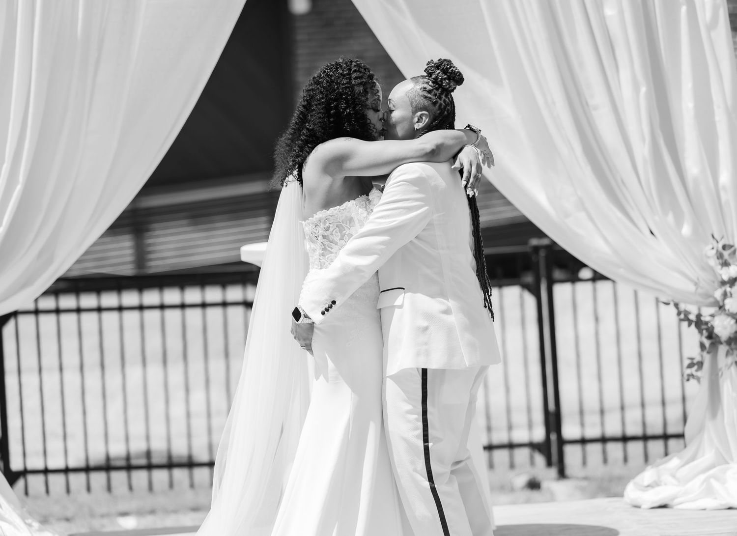 Wedding ceremony moments captured through white flowing drapery panels.