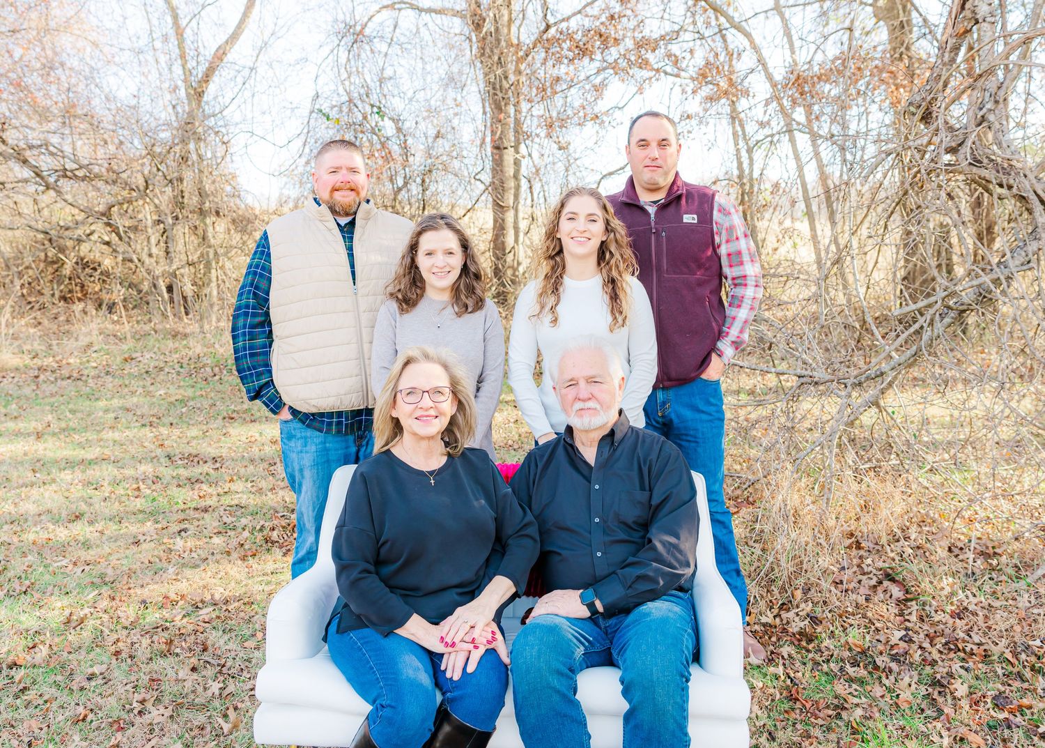 Series of casual family portraits taken outdoors against a natural winter landscape background.