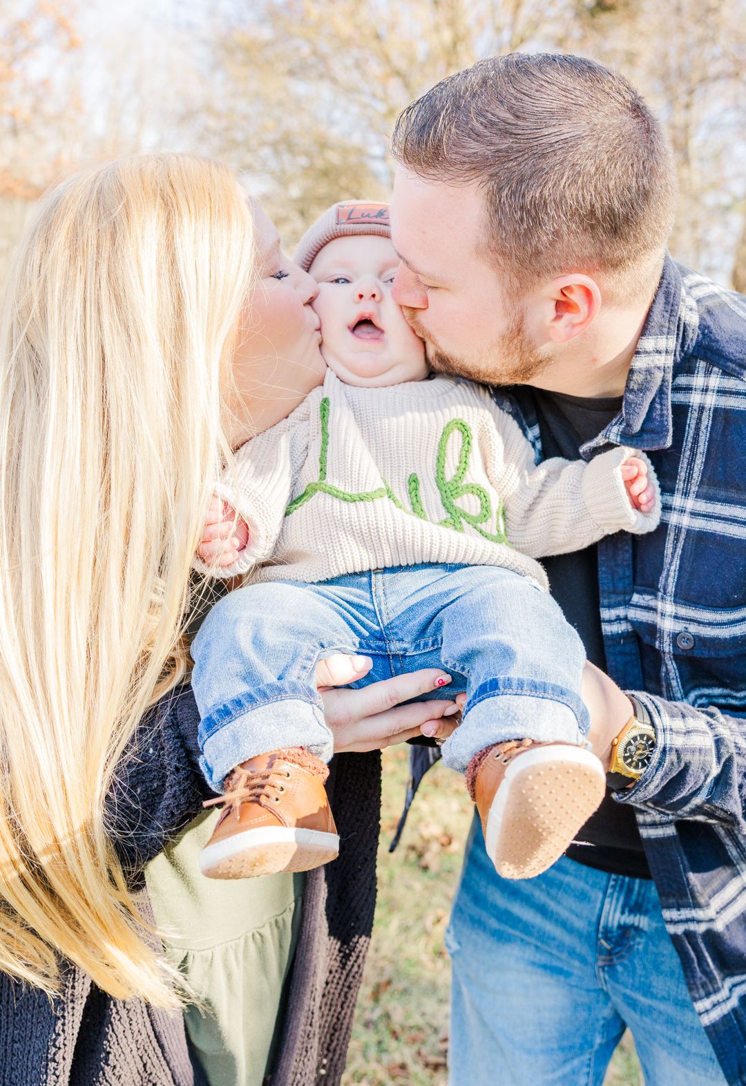 Family shares playful moment outdoors during winter photoshoot.