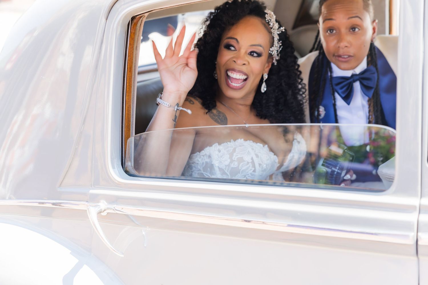 A vintage white wedding car decorated with flowers and ribbons for a special celebration.
