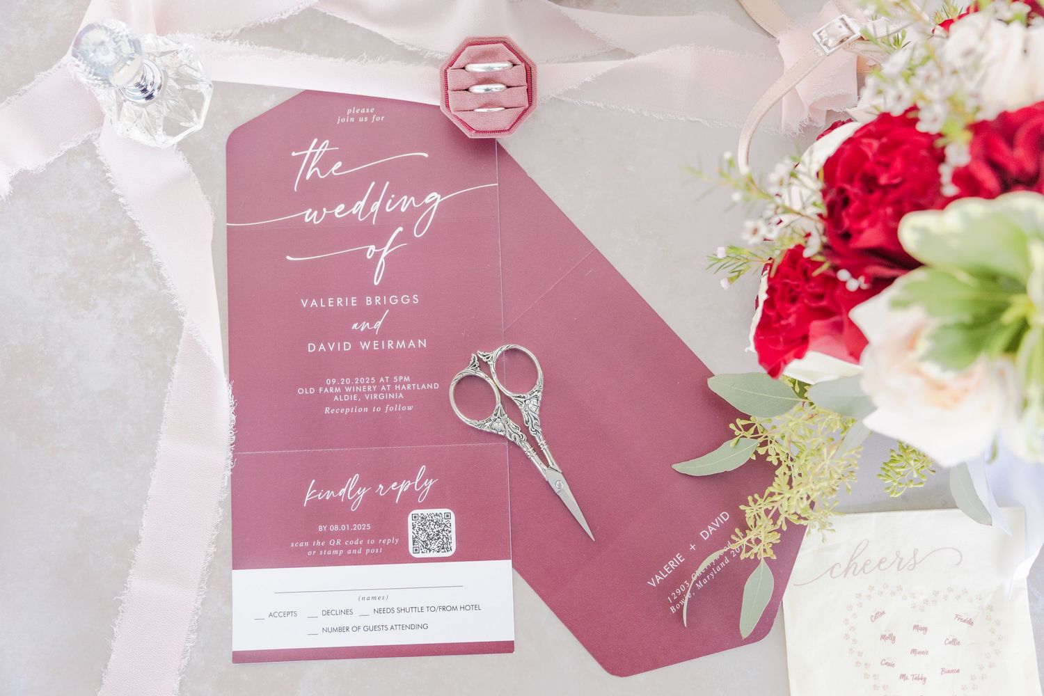 Wedding stationery in burgundy and white with elegant calligraphy and floral details.