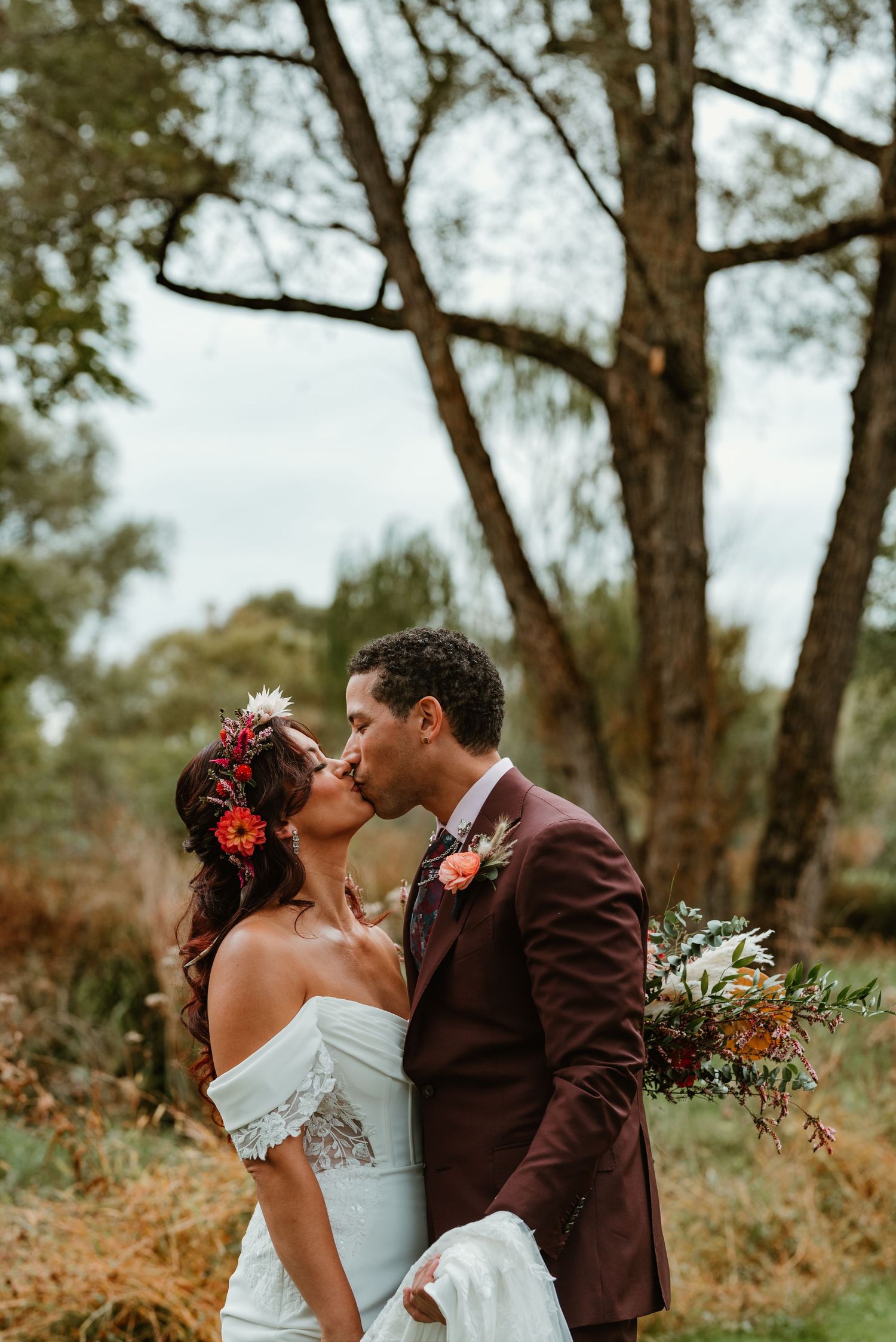 Romantic outdoor wedding photo series showing a couple sharing tender moments in a wooded natural setting.
