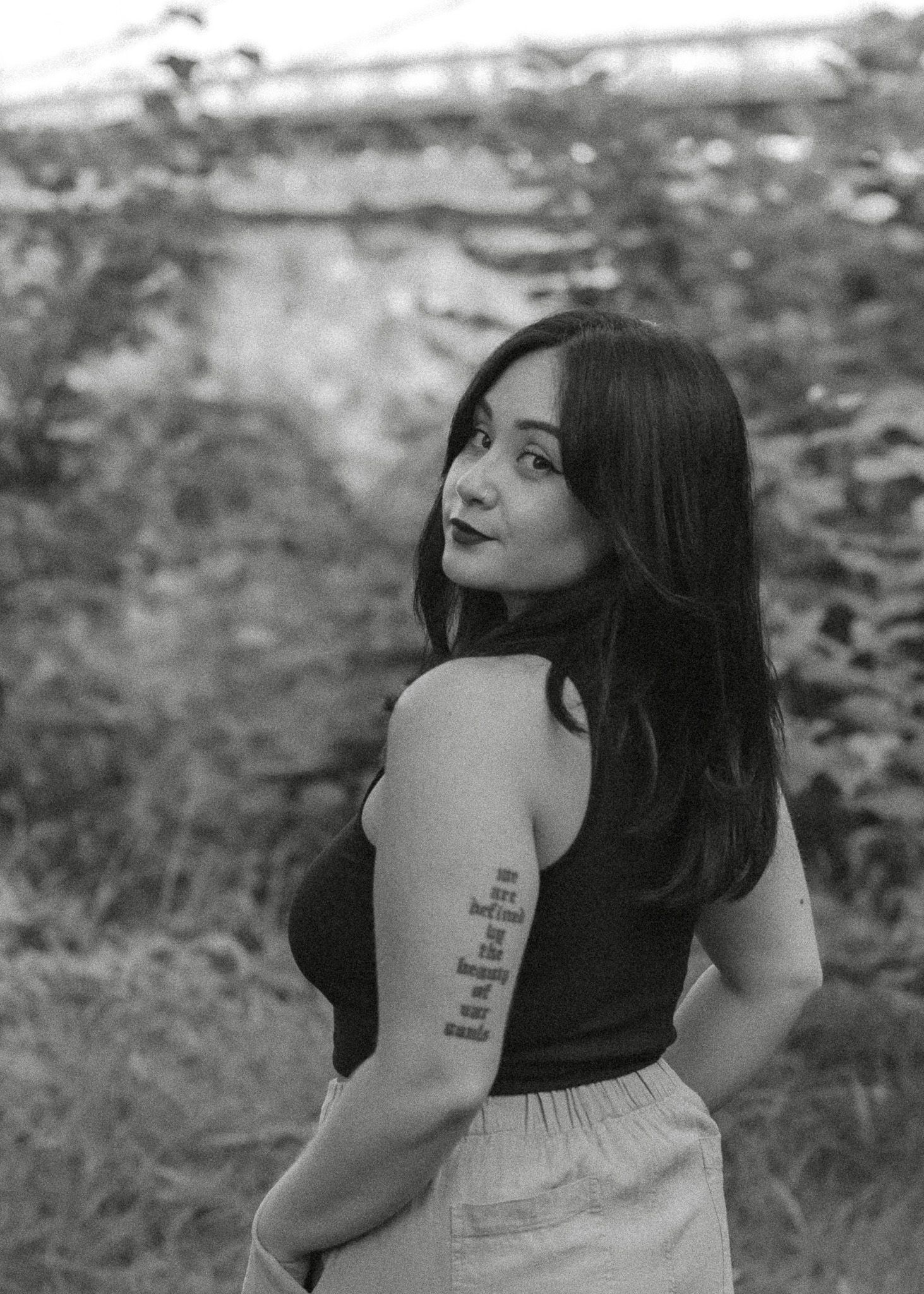 Black and white portrait series showing artistic angles and poses against a natural background.