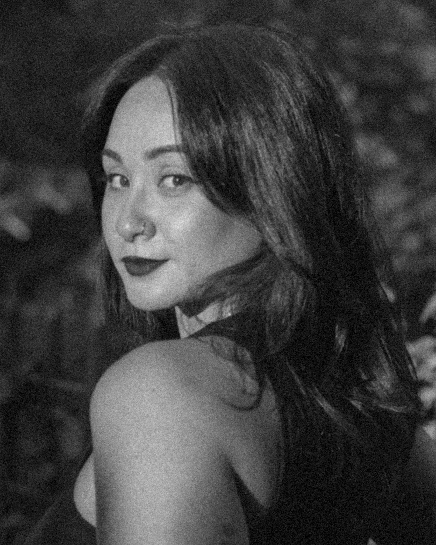 Black and white artistic portrait with dramatic shadows and lighting.