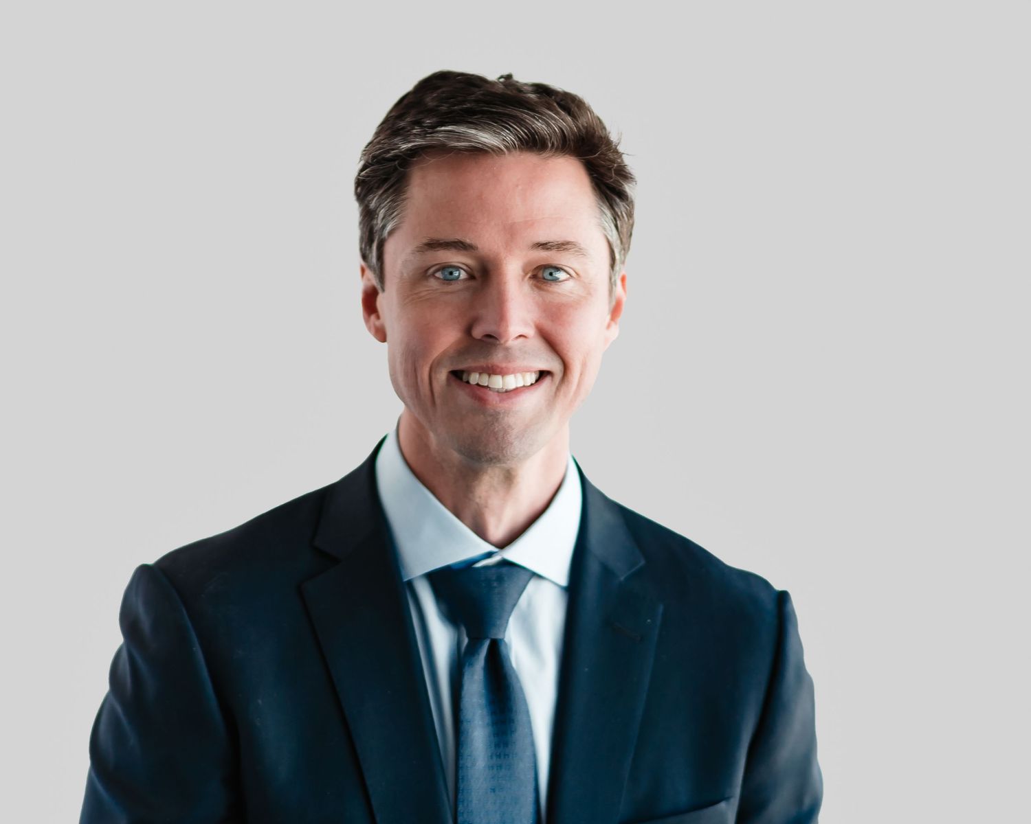 Business portrait series showing confidence and professionalism in a navy suit.