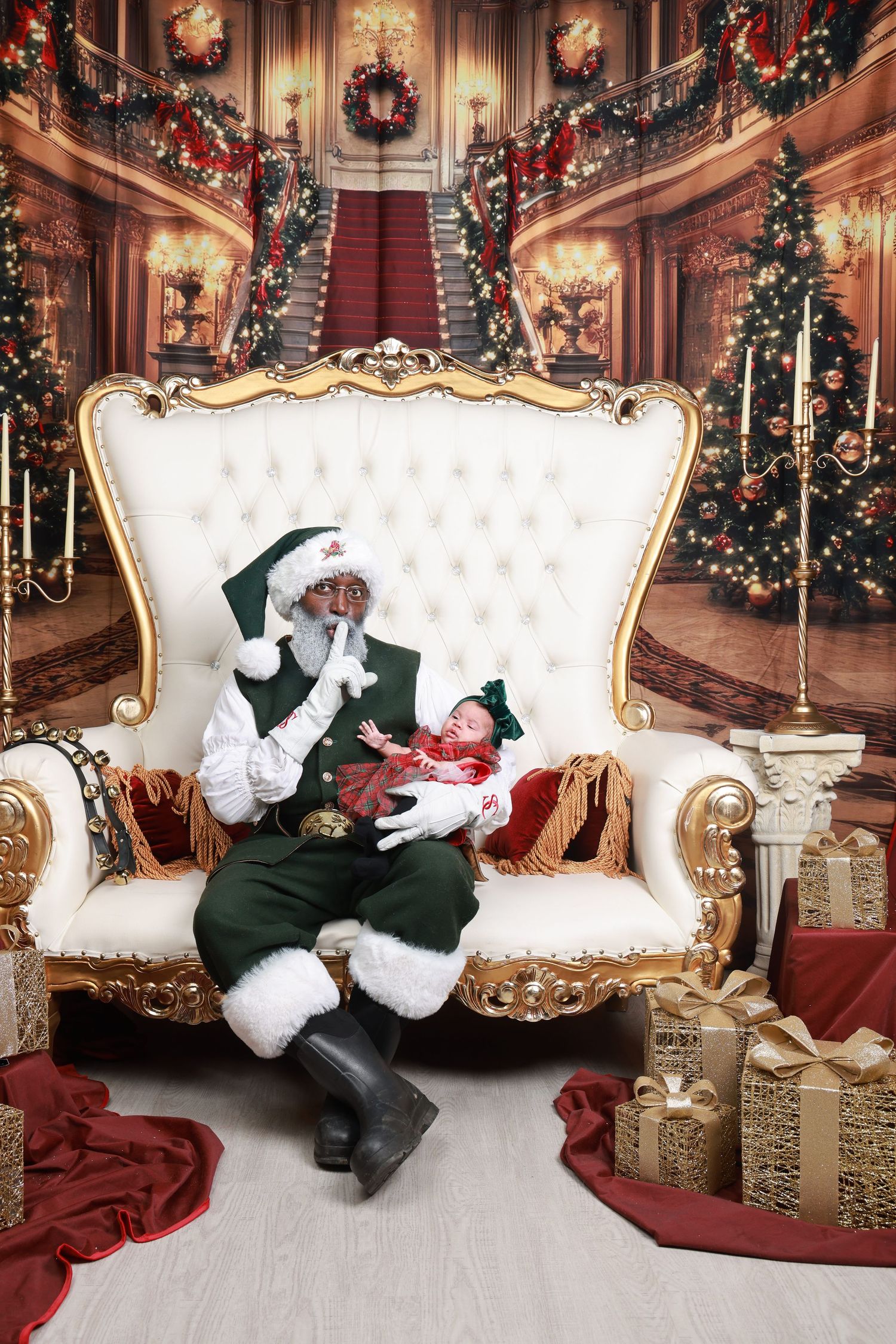 Elegant Victorian-style Christmas scene with white tufted loveseat, decorated trees, and festive holiday decor in grand setting.