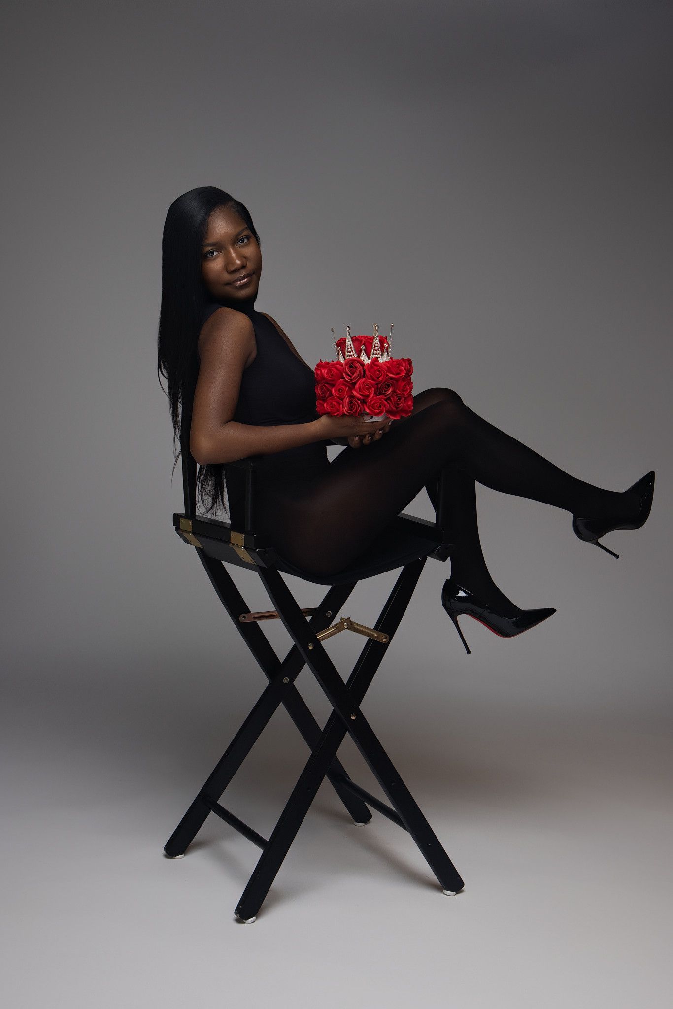 A series of artistic studio portraits featuring someone in black attire posing with a red rose on a director's chair.