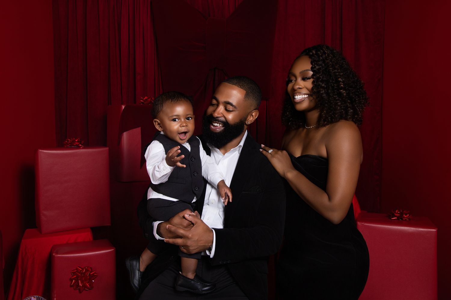 A group shares joyful moments together in an elegant red-toned theater or auditorium setting.