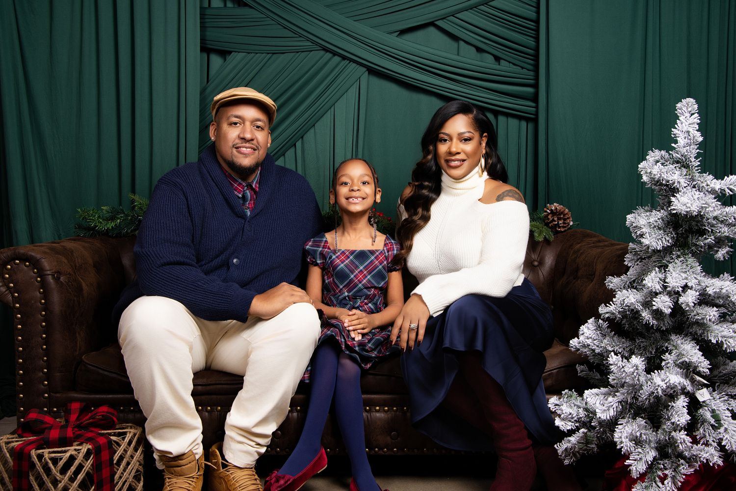 Family portrait session in front of a Christmas tree showing multiple poses and holiday outfits.