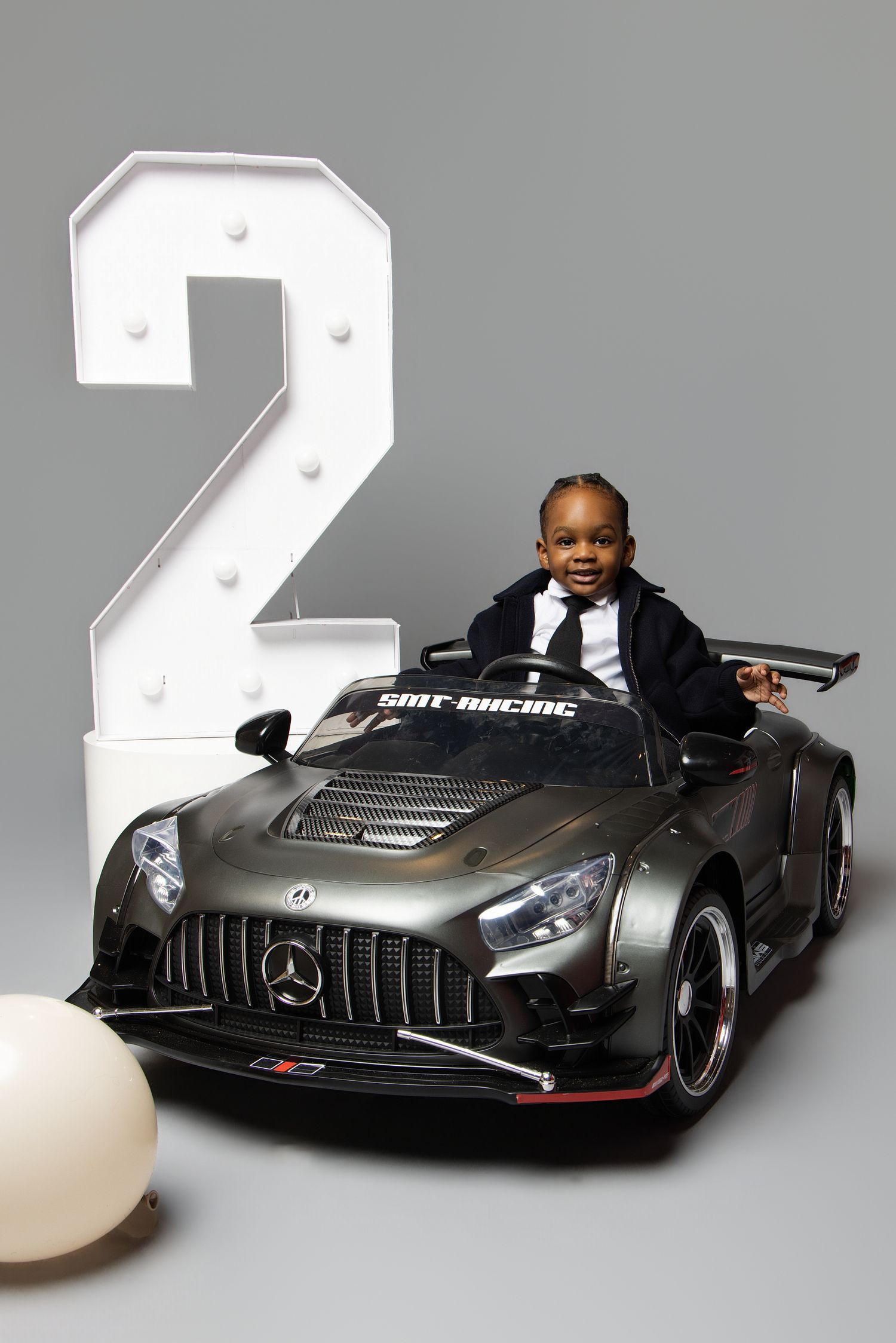 A sleek black Mercedes-Benz concept car shown from multiple angles in a studio setting with dramatic lighting.