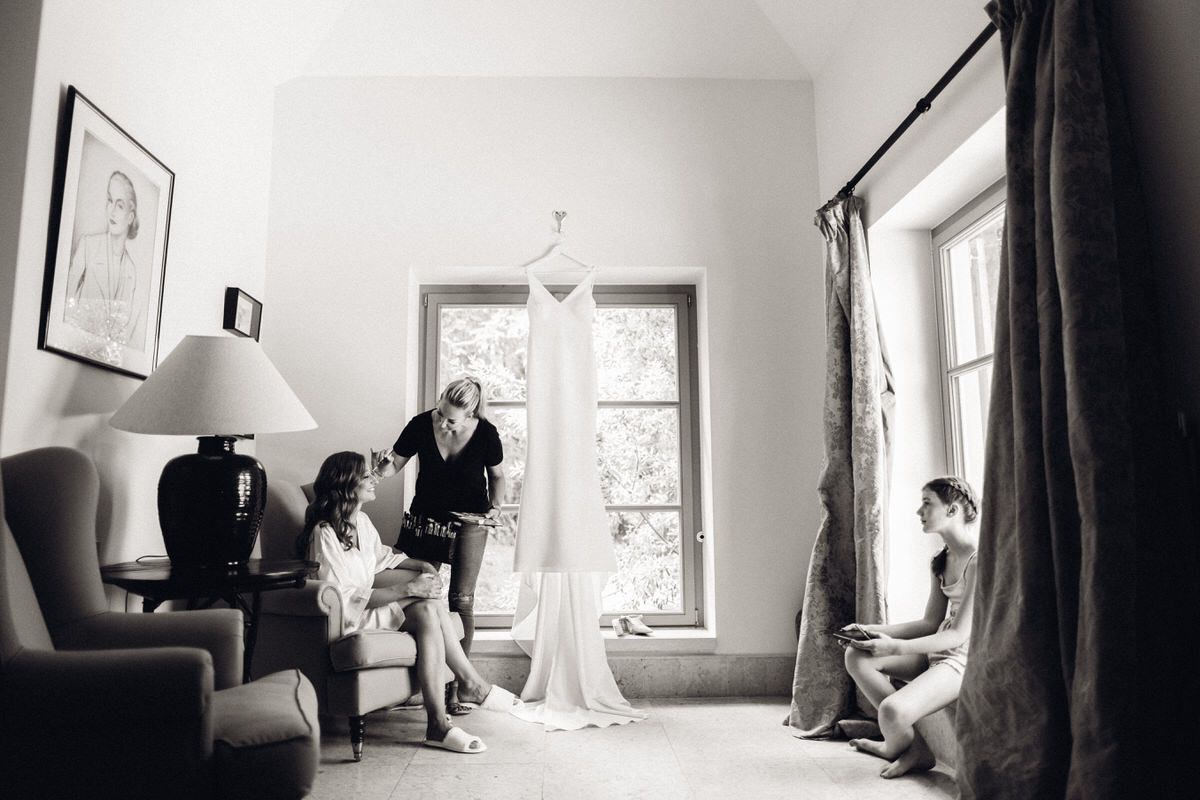 Bride getting ready with friends in a bright room, emotional moments before the wedding ceremony