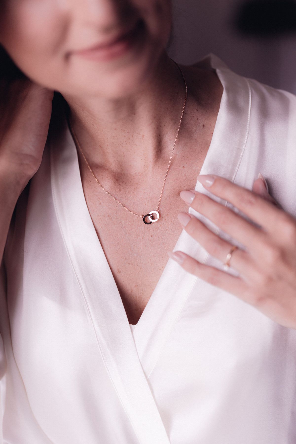 Close-up of bride’s necklace and dress neckline, elegant bridal styling detail