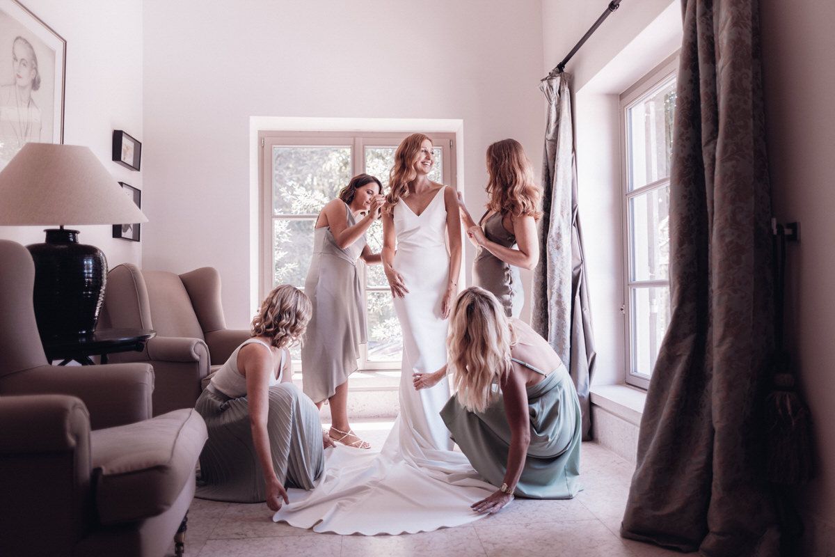 Bride entering the room with bridesmaids, emotional and candid wedding moment