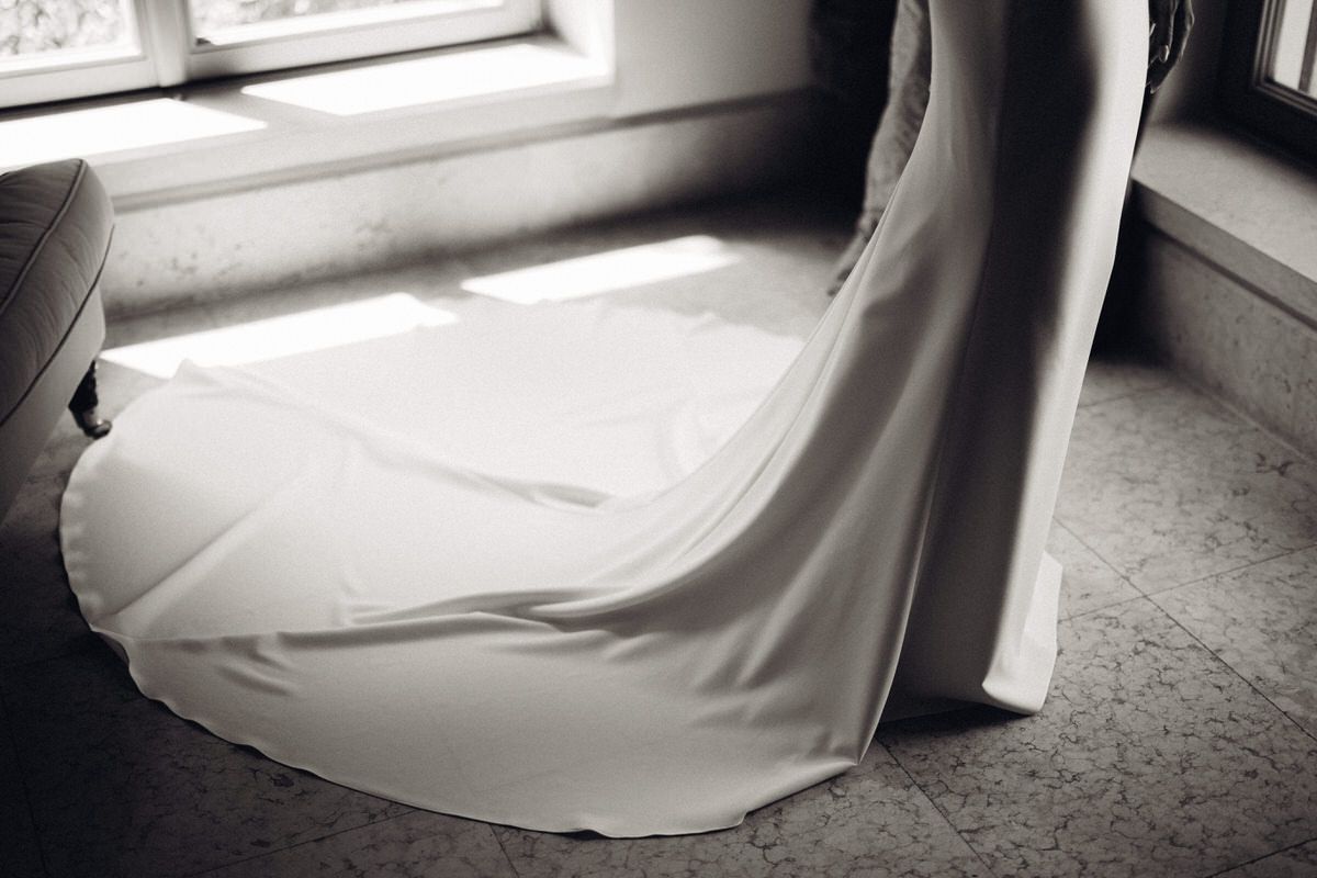 Detail of wedding dress hem flowing on the floor, soft textures and movement
