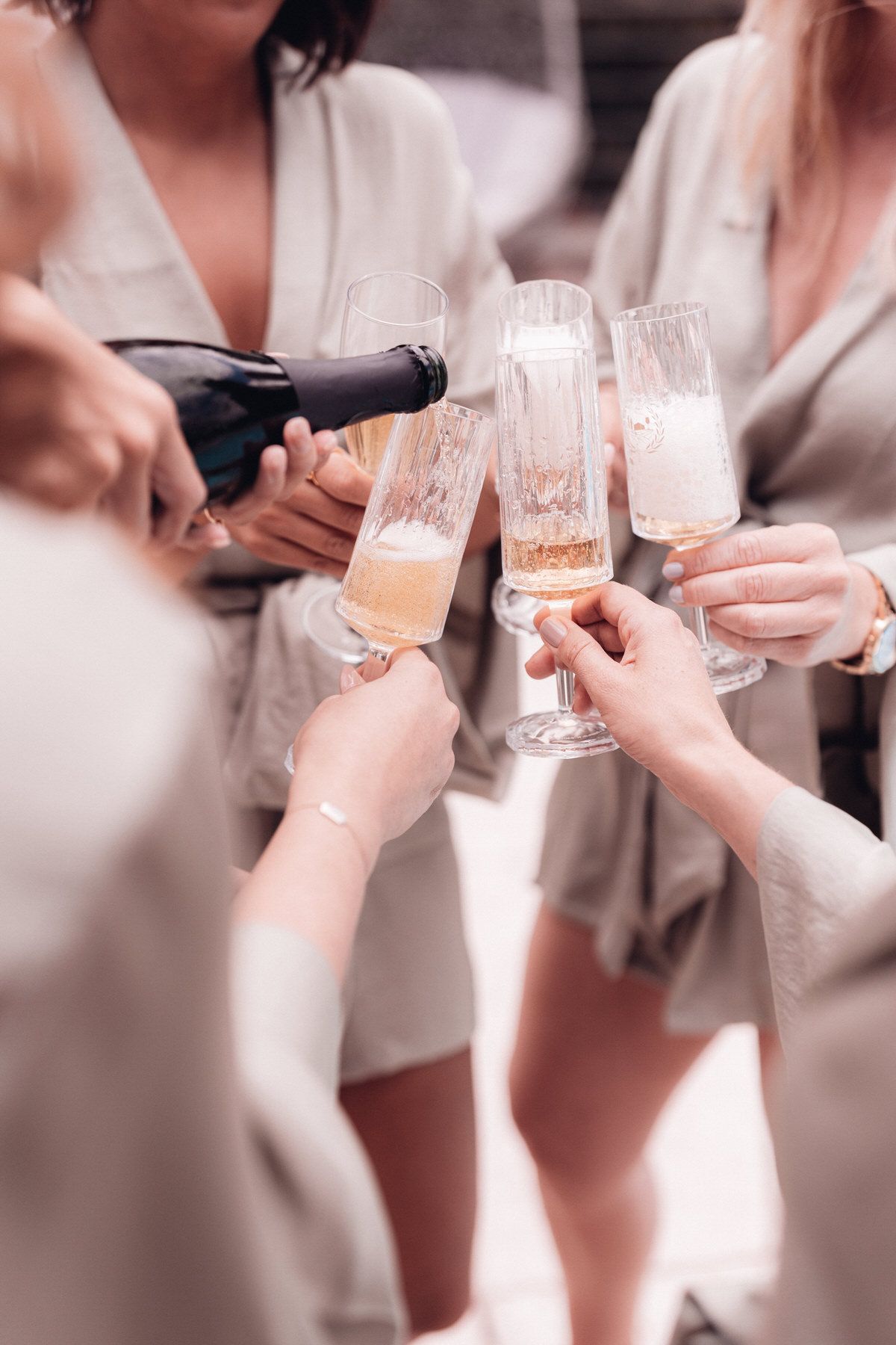 Bridesmaids toasting with champagne during wedding morning, joyful and relaxed atmosphere