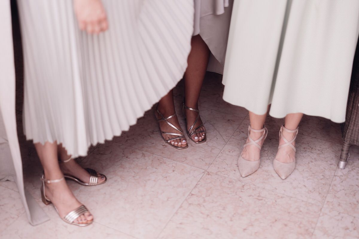 Bridesmaids’ shoes and dresses detail, coordinated and elegant wedding styling