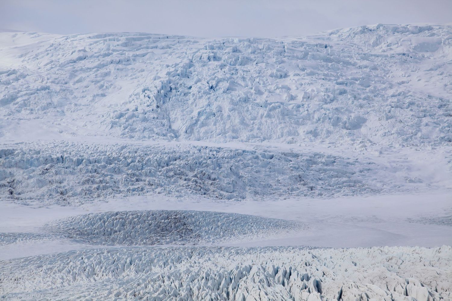 Vast snow-covered glacier landscape stretching across mountainous terrain.