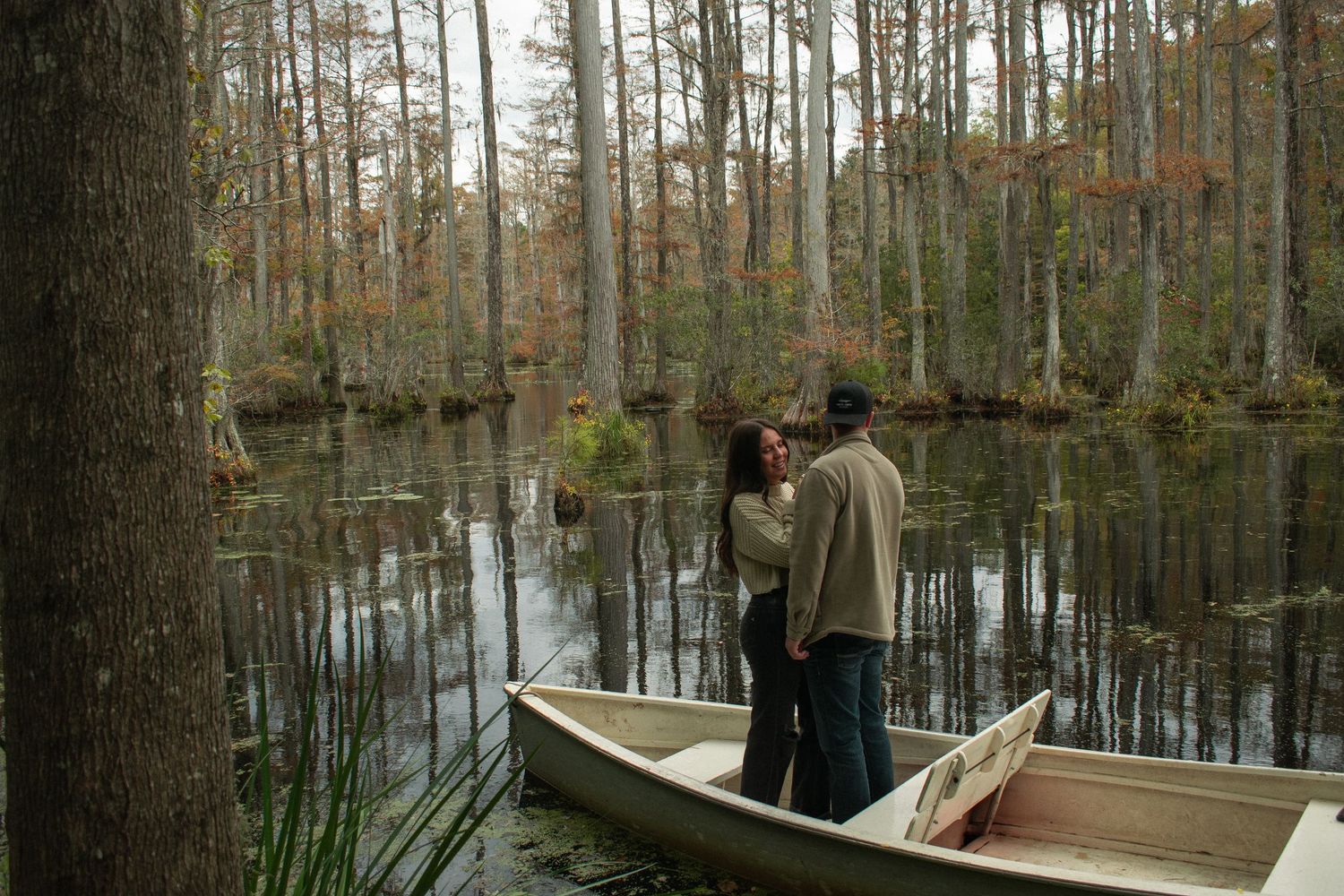 A romantic boat ride through a cypress swamp with autumn foliage.