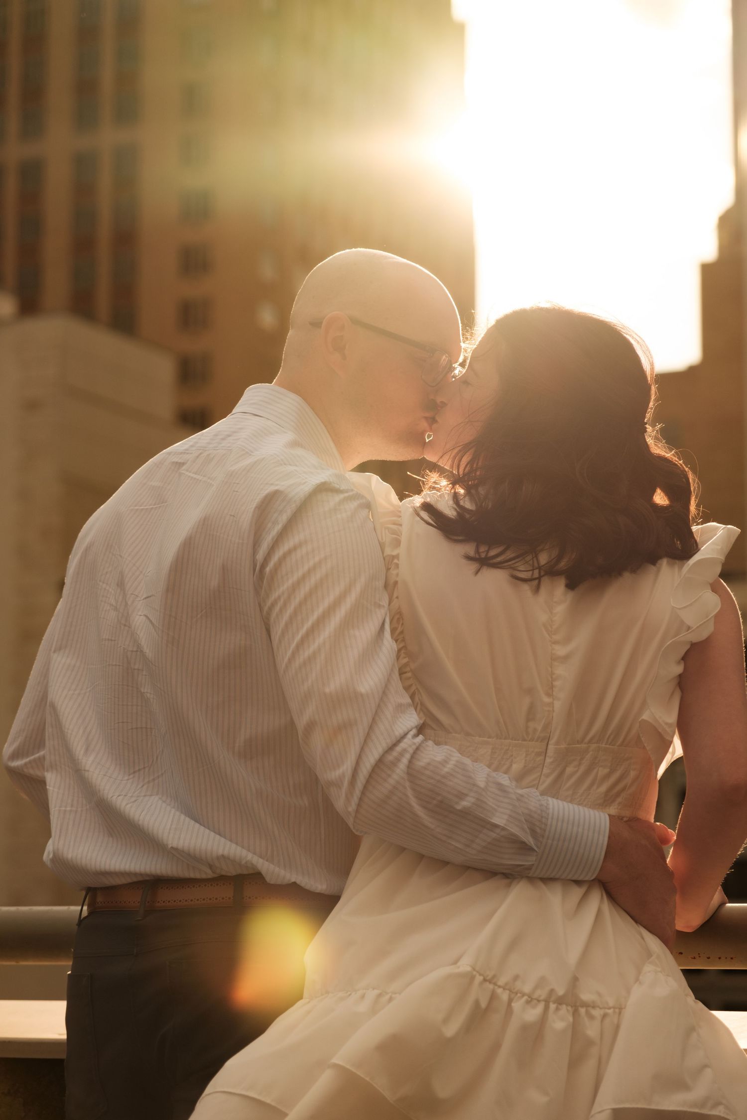 Couple shares a kiss at golden hour, engagement photos, Houston, Tx