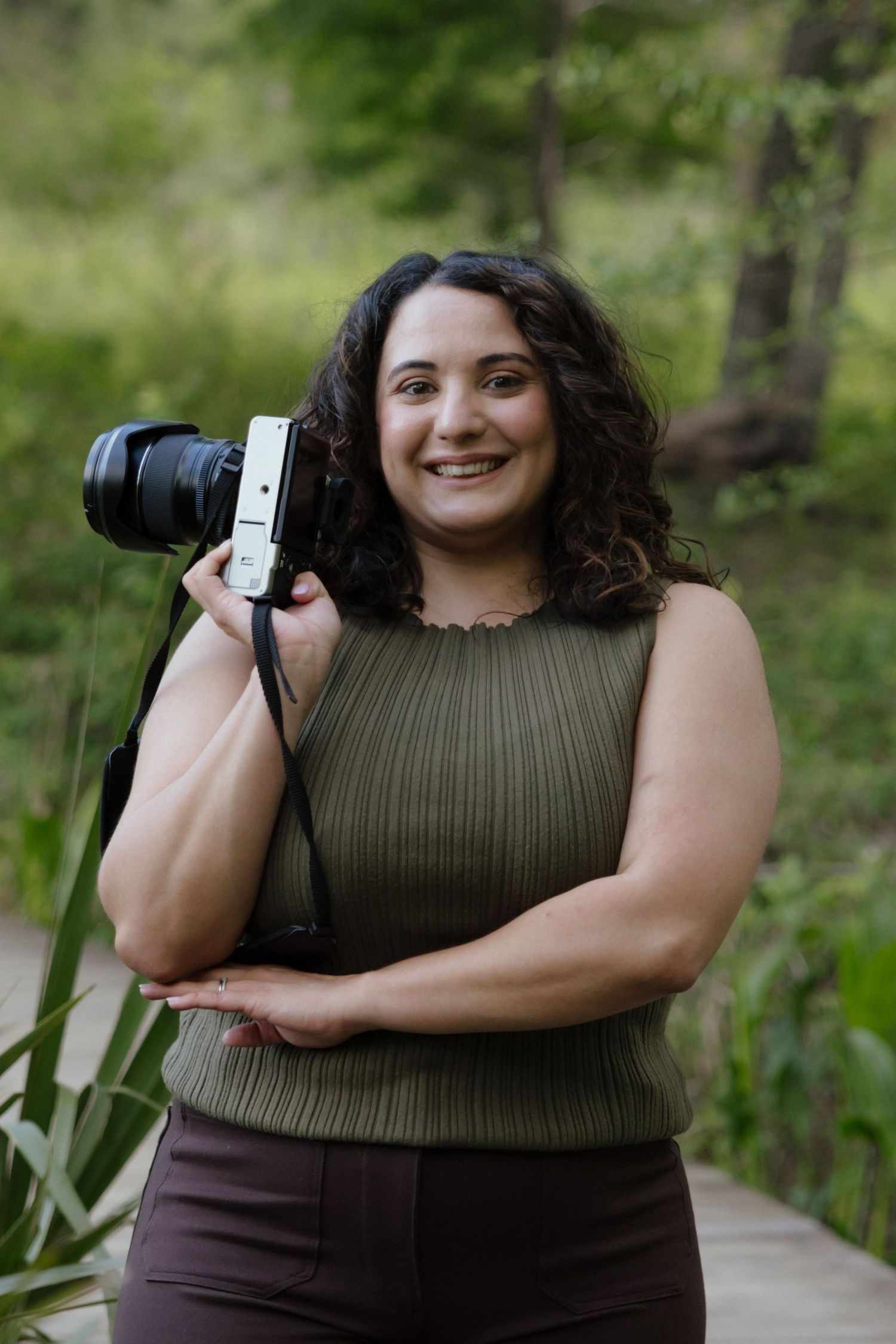 Professional photographer in Houston Texas holds fujifilm camera