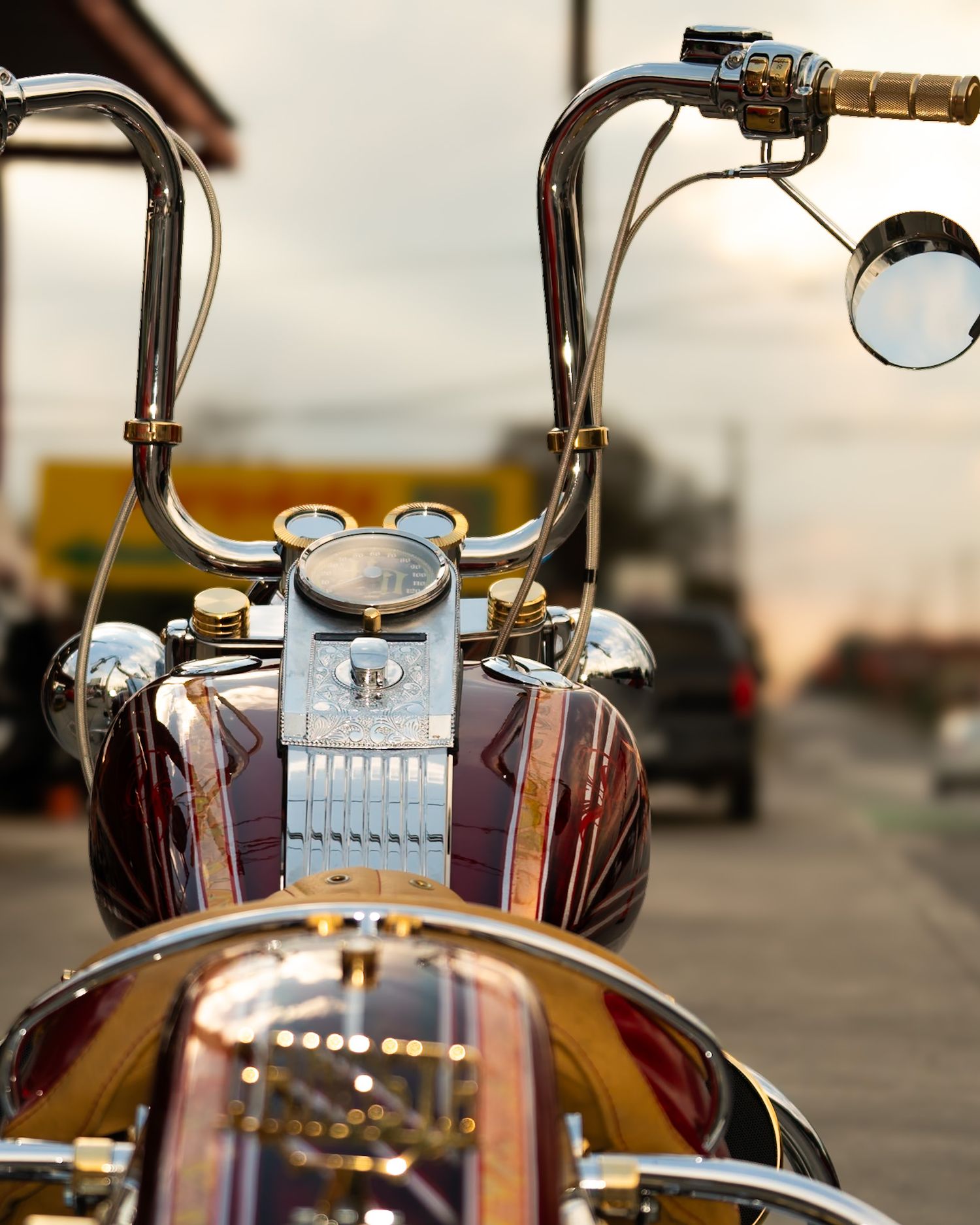 Close-up details of a custom motorcycle's handlebars and controls in dramatic lighting. Captured by a Seguin photographer at grain n glass