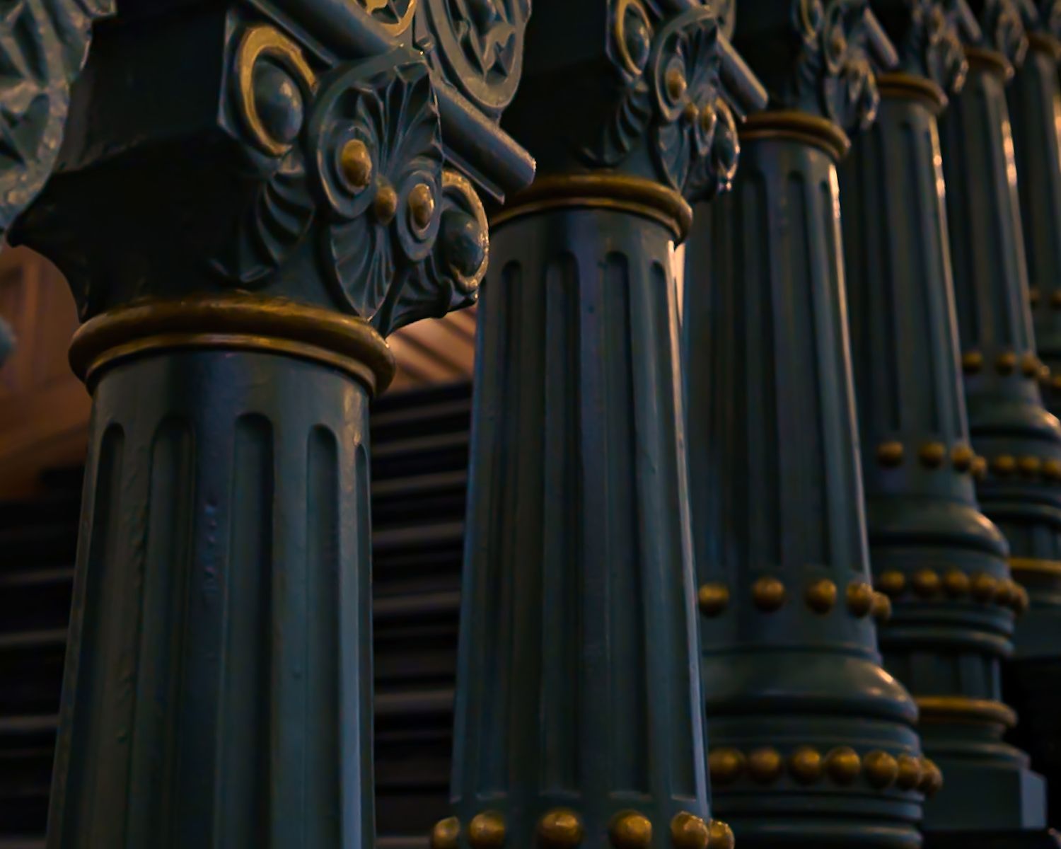 Architectural detail of ornate dark metal columns with gold accents at the Tx capital. Captured by a Seguin photographer at grain n glass