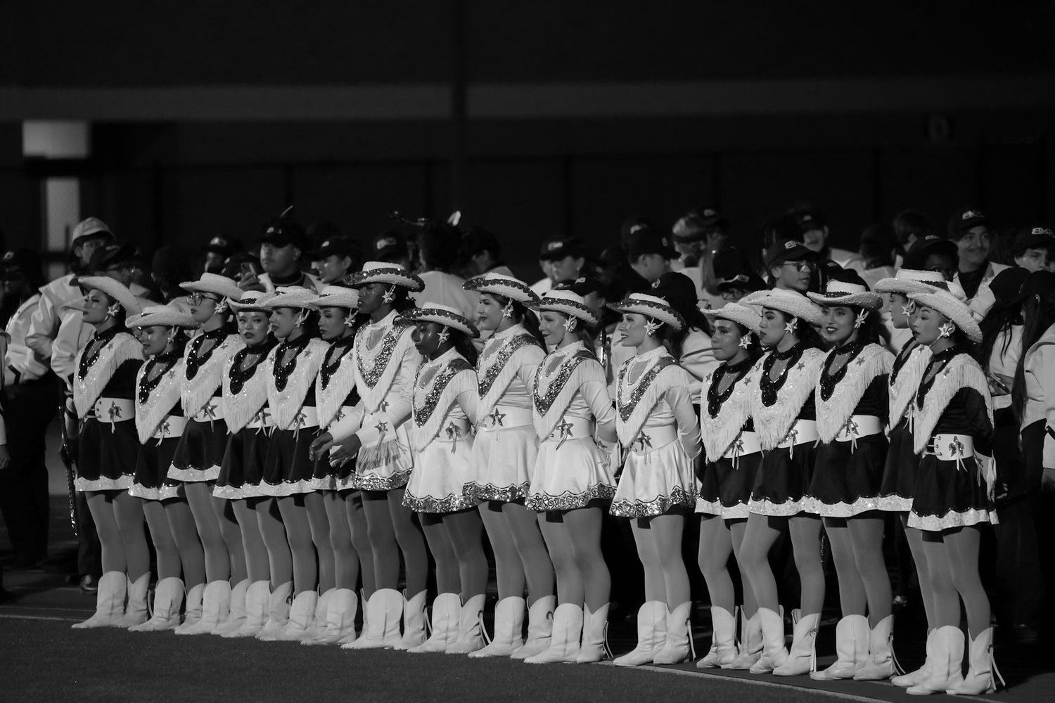 high school dancers stand in formation for a historical black and white photograph. Captured by a Seguin photographer at grain n glass
