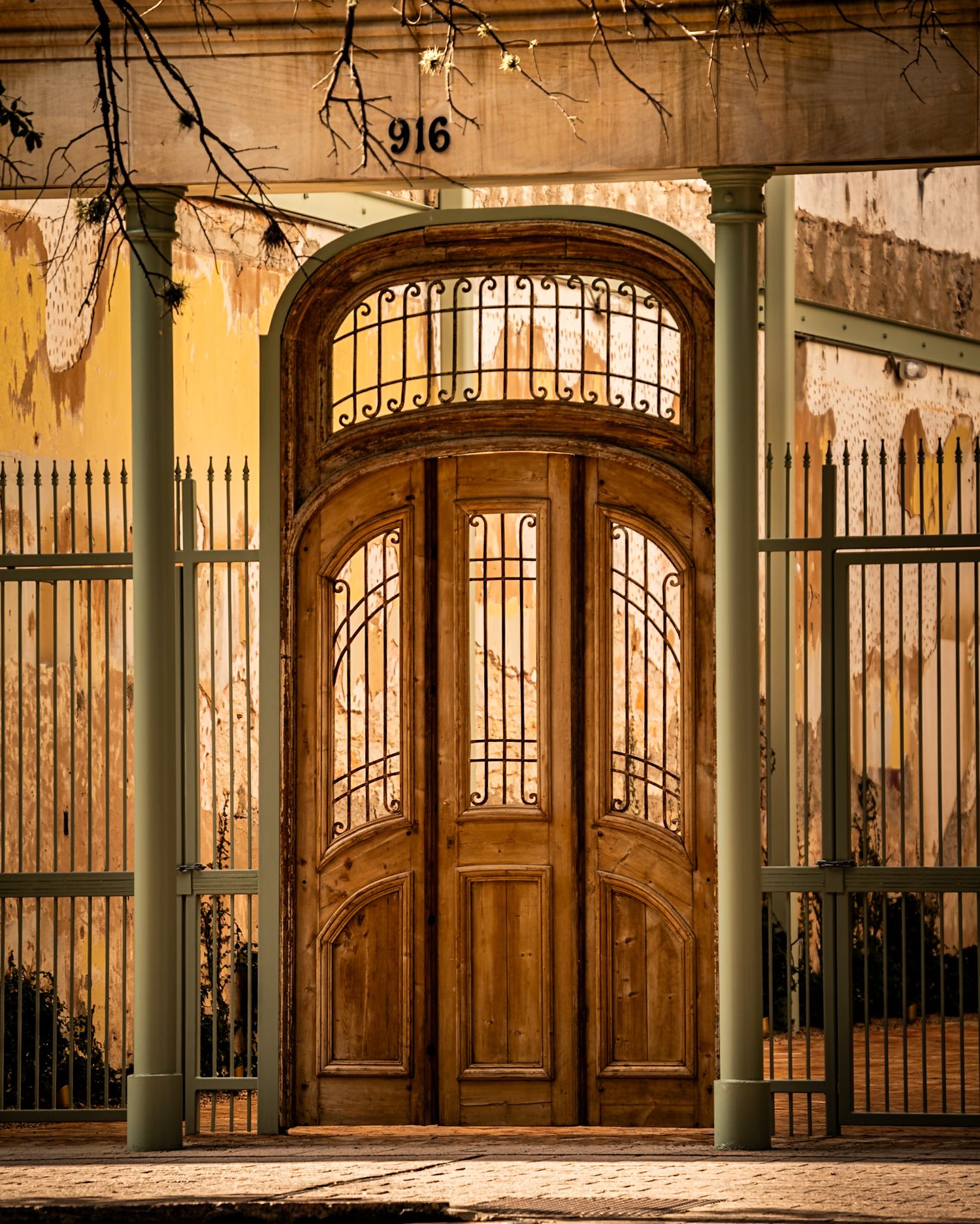 Ornate wooden and iron gates with arched doorways in historic architecture. Captured by a Seguin photographer at grain n glass