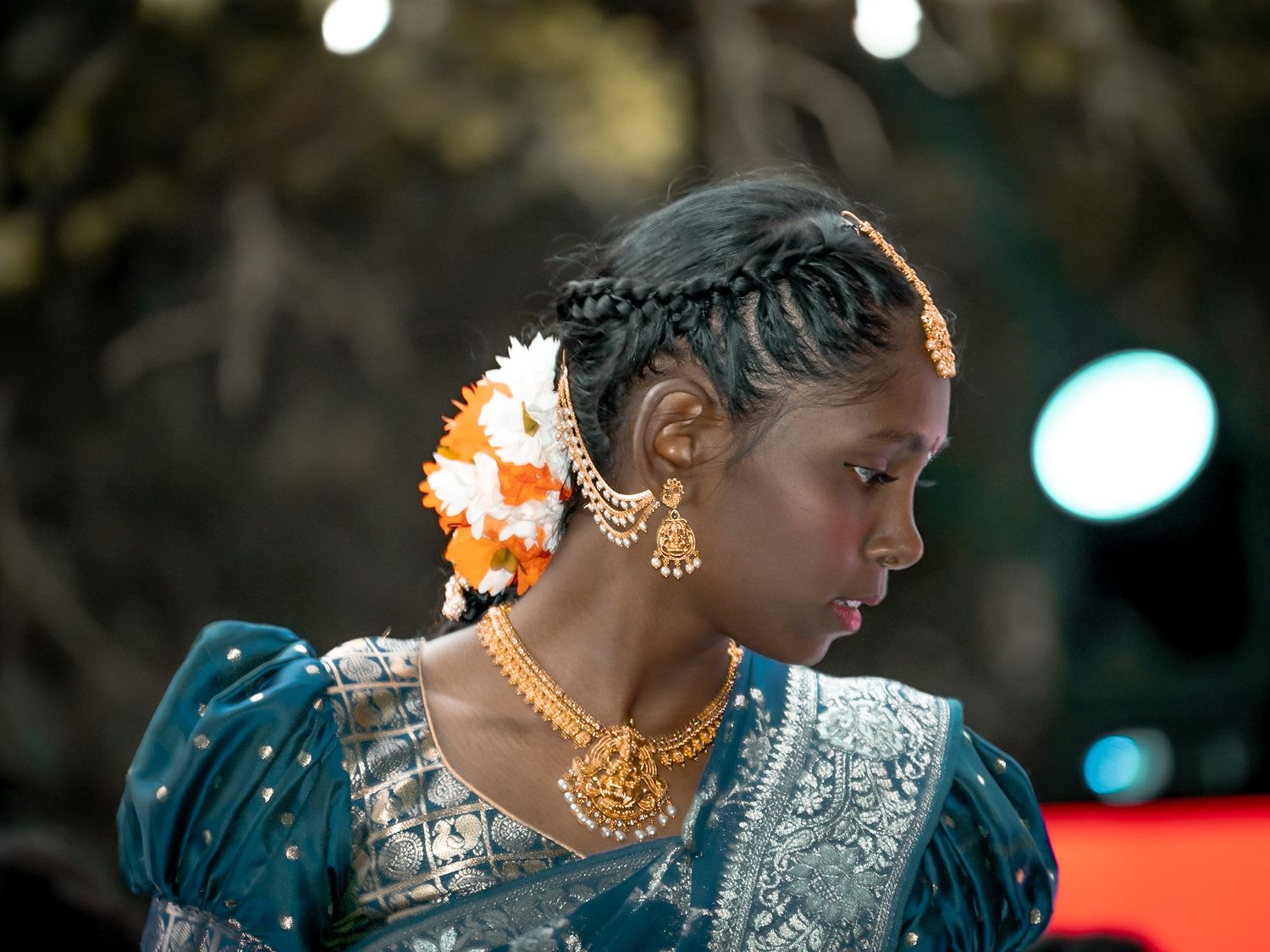 Girl wearing traditional Indian attire with jewelry and decorative elements Dancing. Captured by a Seguin photographer at grain n glass