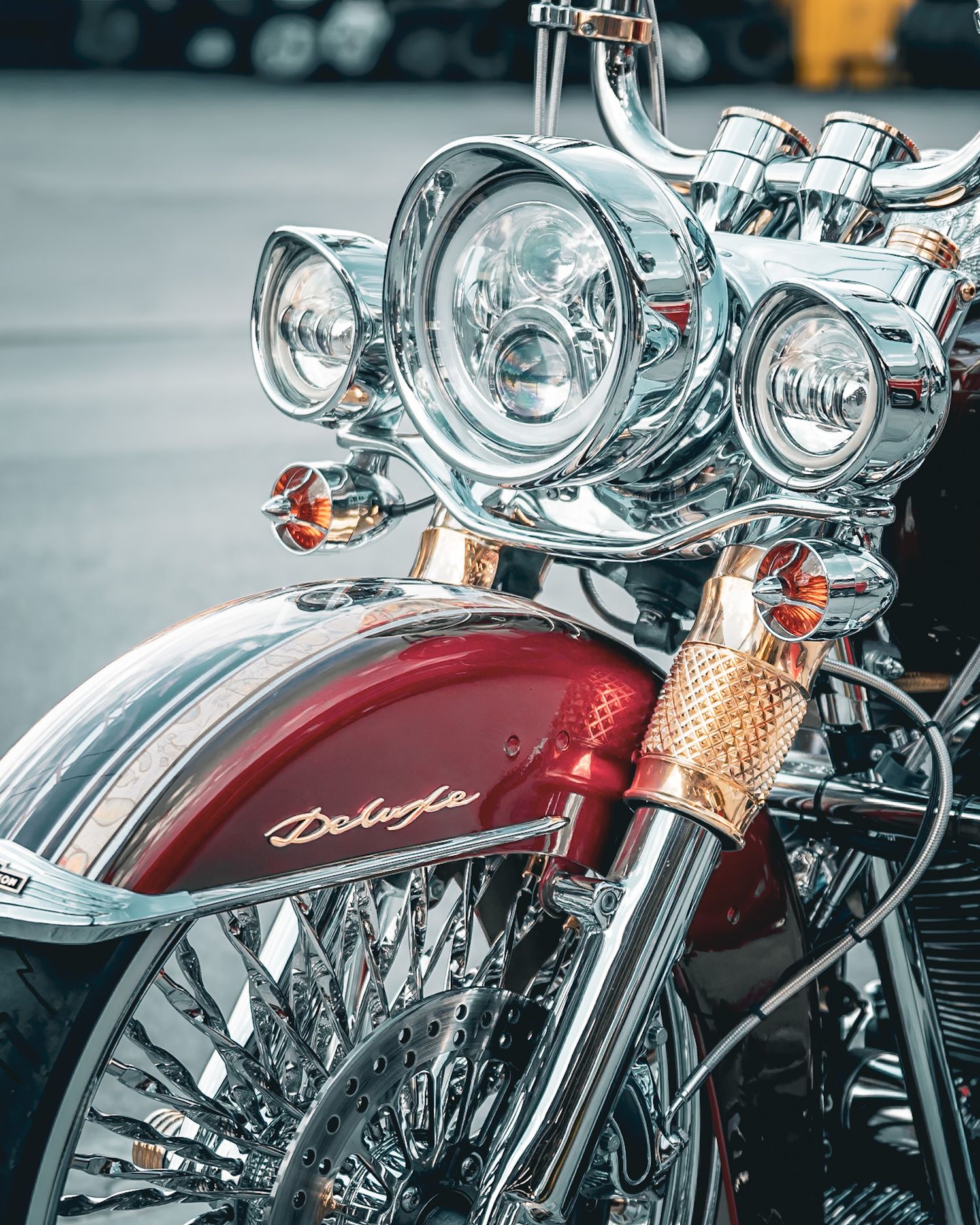 Close-up of a red and chrome Indian motorcycle's front end and handlebars. Captured by a Seguin photographer at grain n glass
